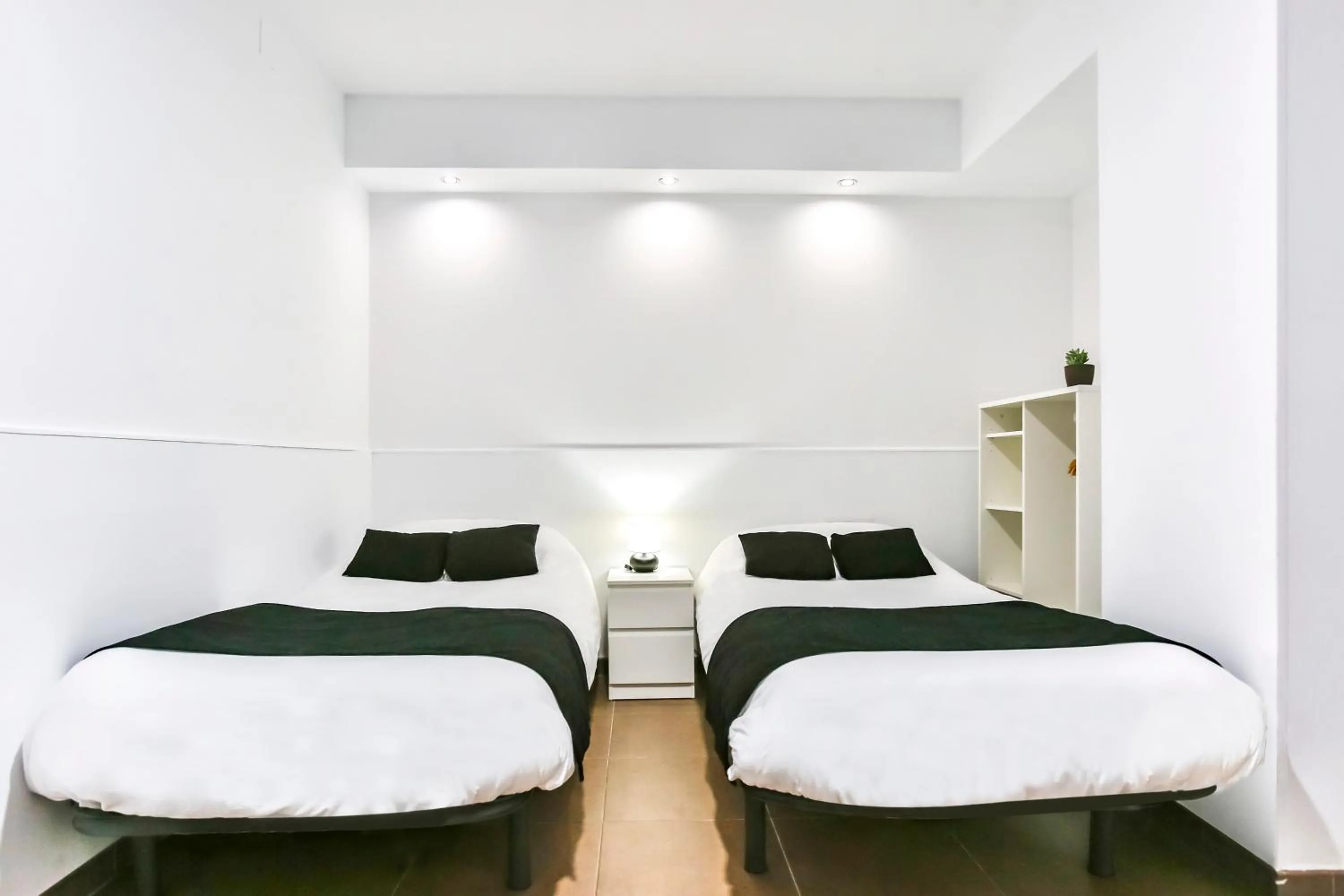 Bed in Laramond Barcelona Rooms