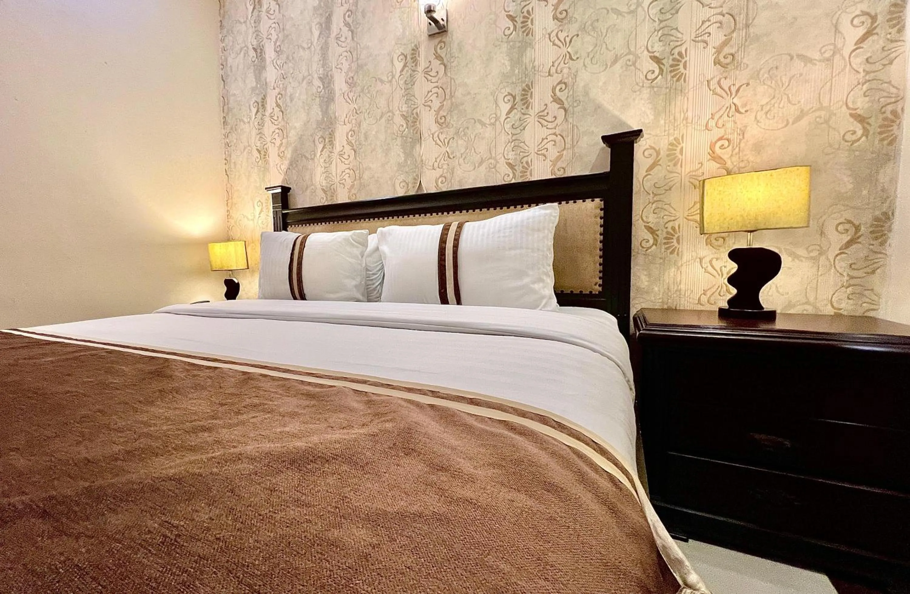 Bed in Royal Inn Hotel