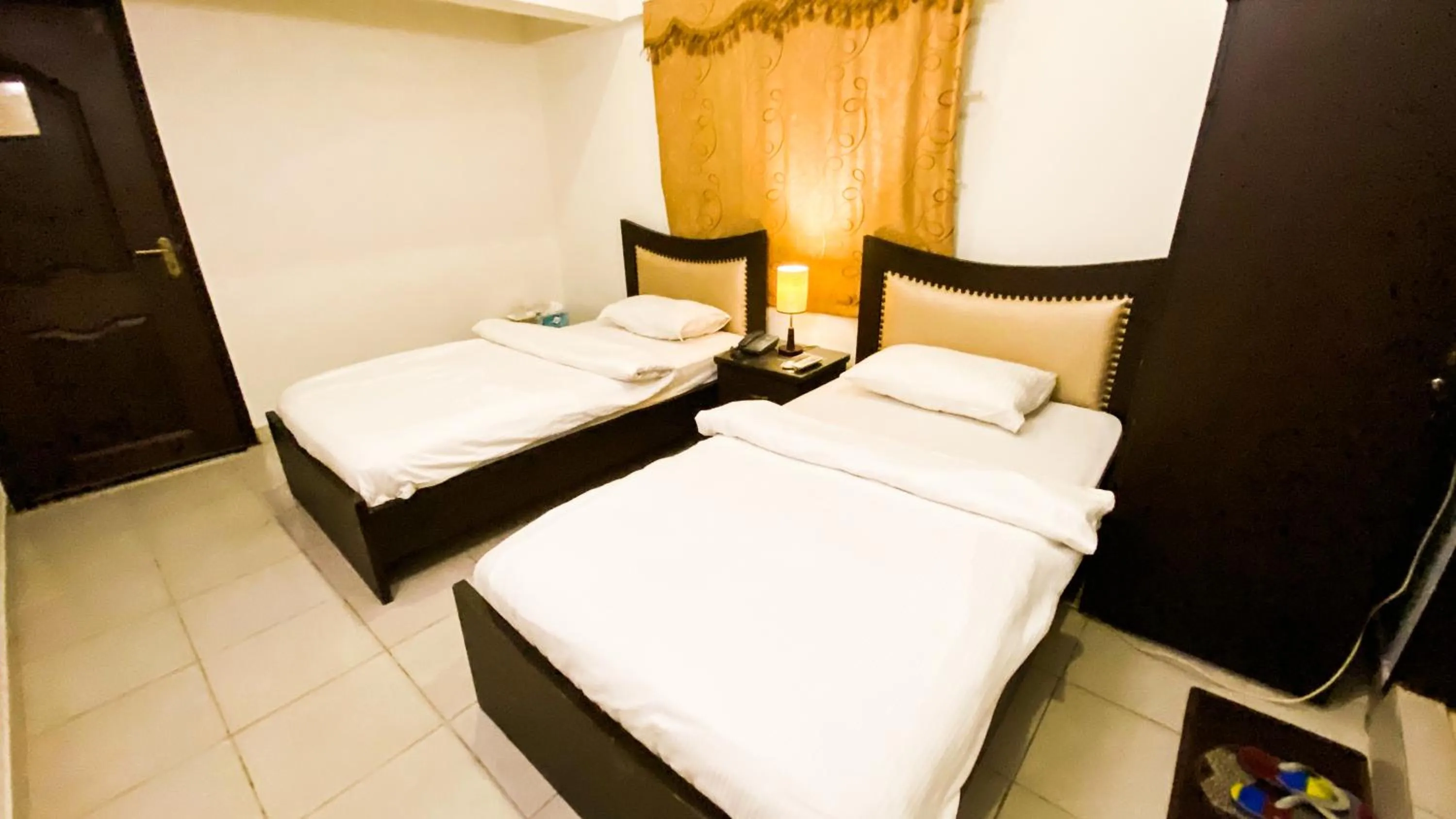 Bed in Royal Inn Hotel