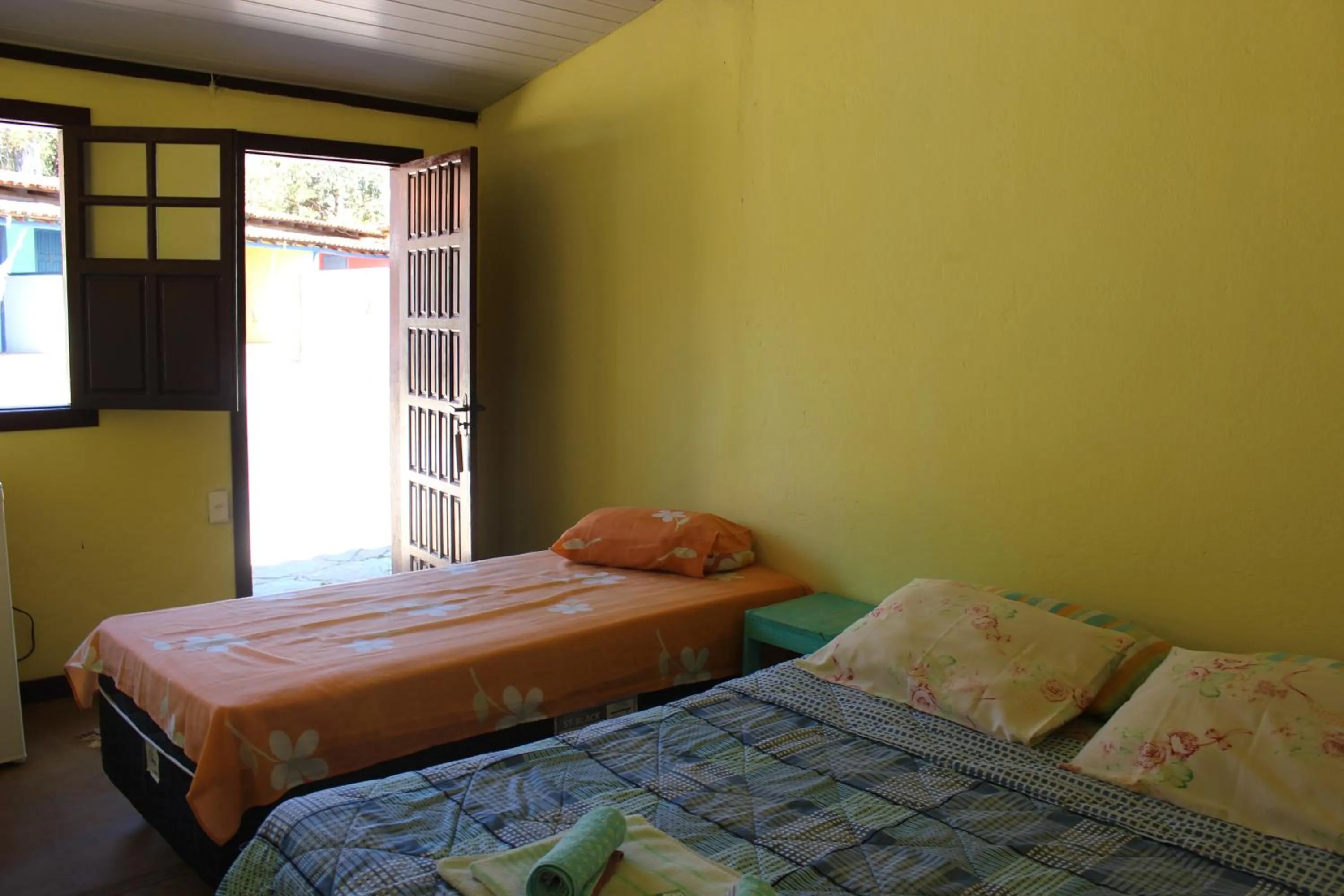 Bed in Pousada Vila Cipó