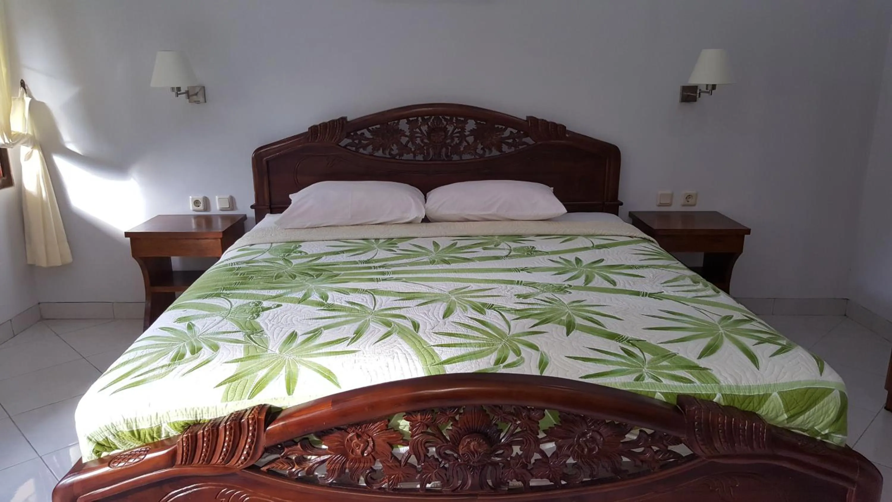 Bed in Sari Inn Kuta Lombok