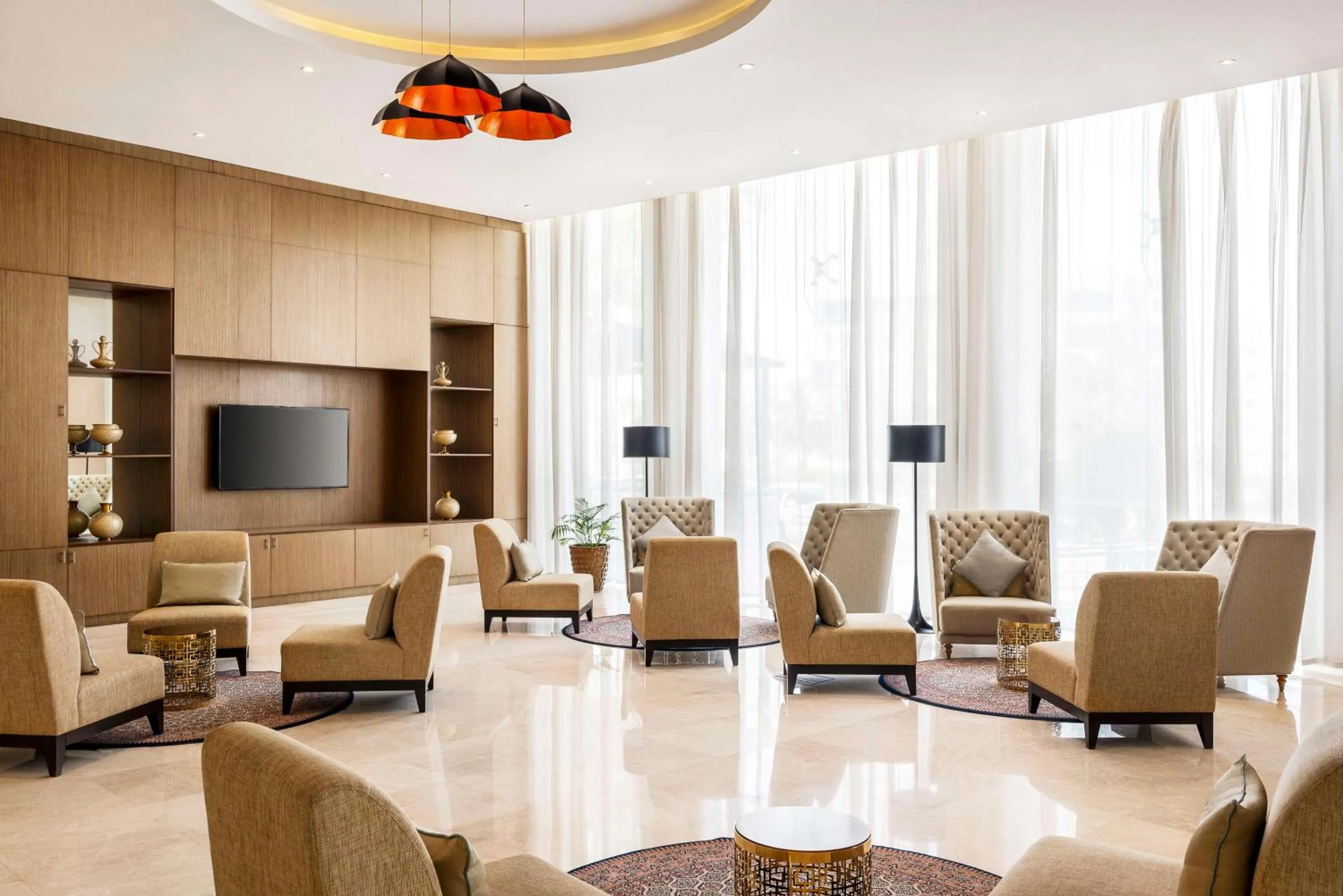 Communal lounge/ TV room in Levatio Suites Muscat, a member of Radisson Individuals