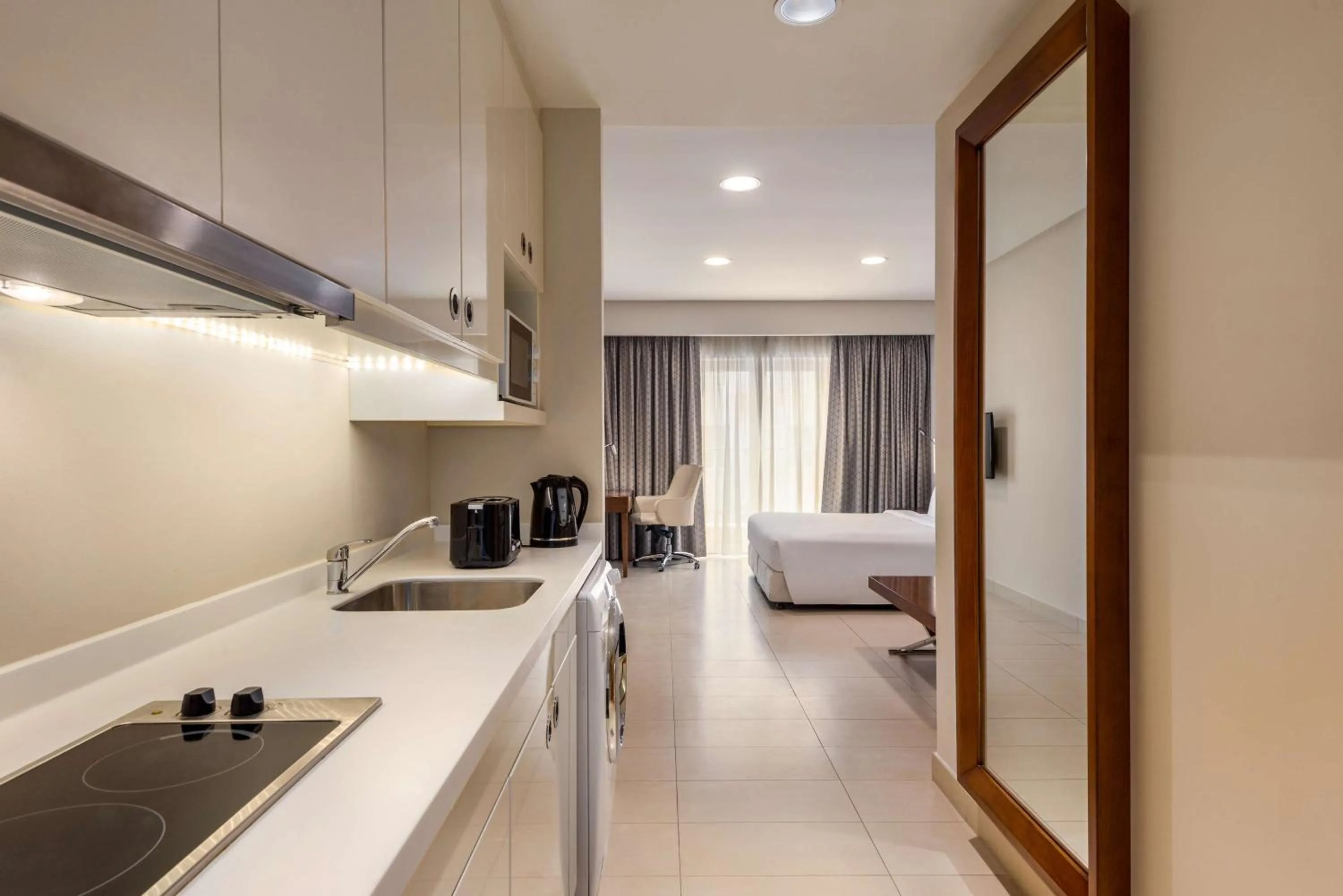Kitchen or kitchenette, Bed in Levatio Suites Muscat, a member of Radisson Individuals