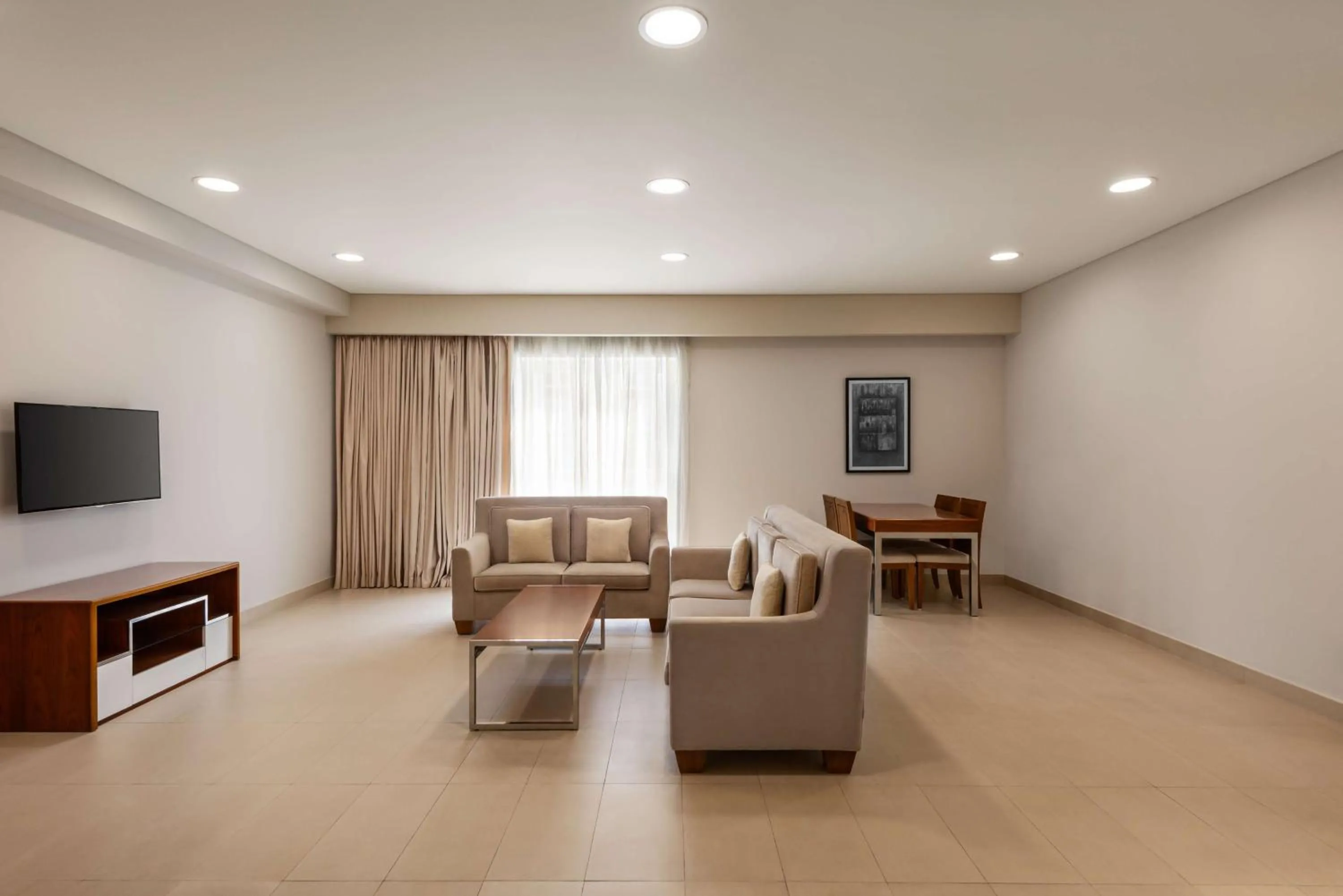 Communal lounge/ TV room in Levatio Suites Muscat, a member of Radisson Individuals