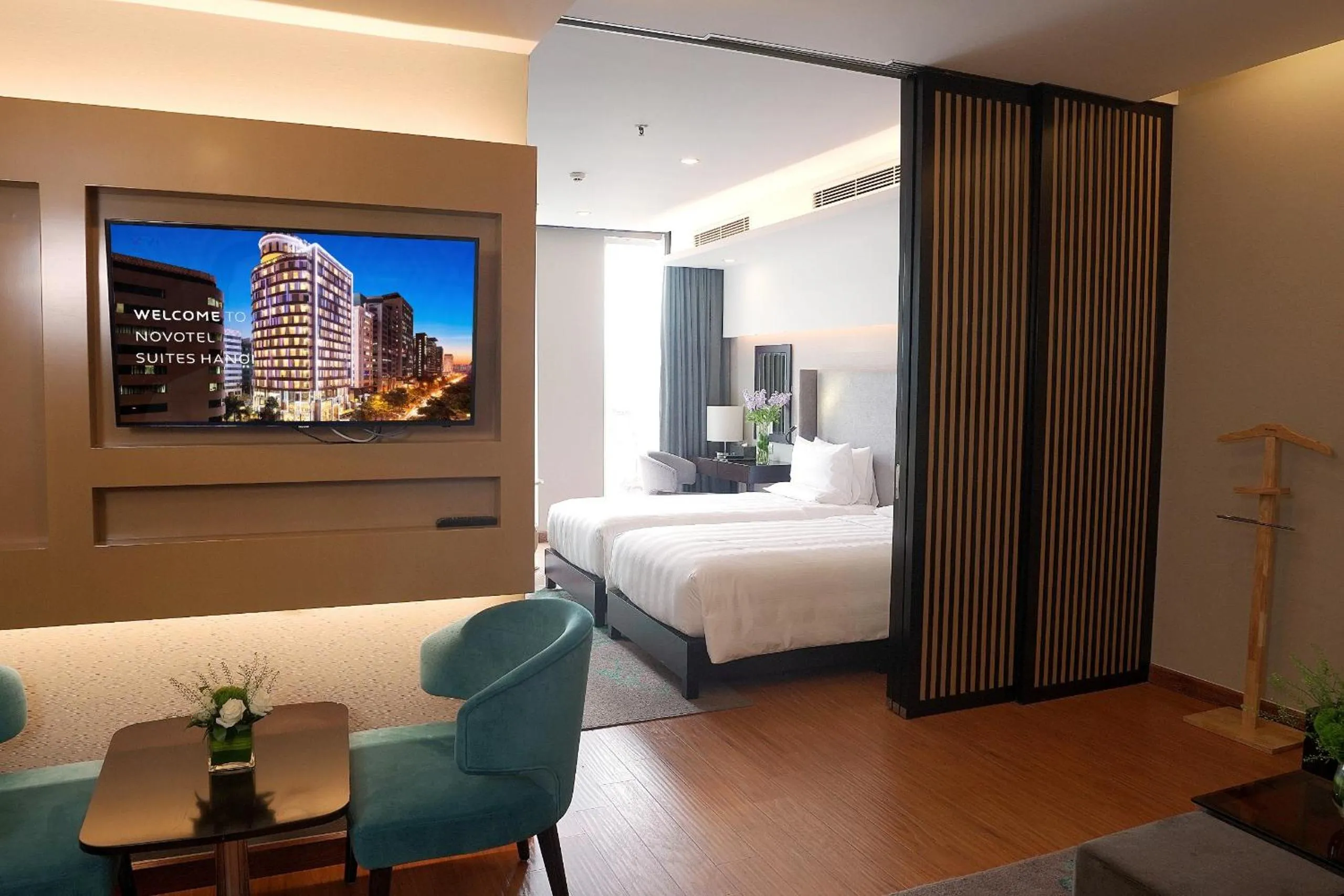 Living room, Bed in Novotel Suites Hanoi