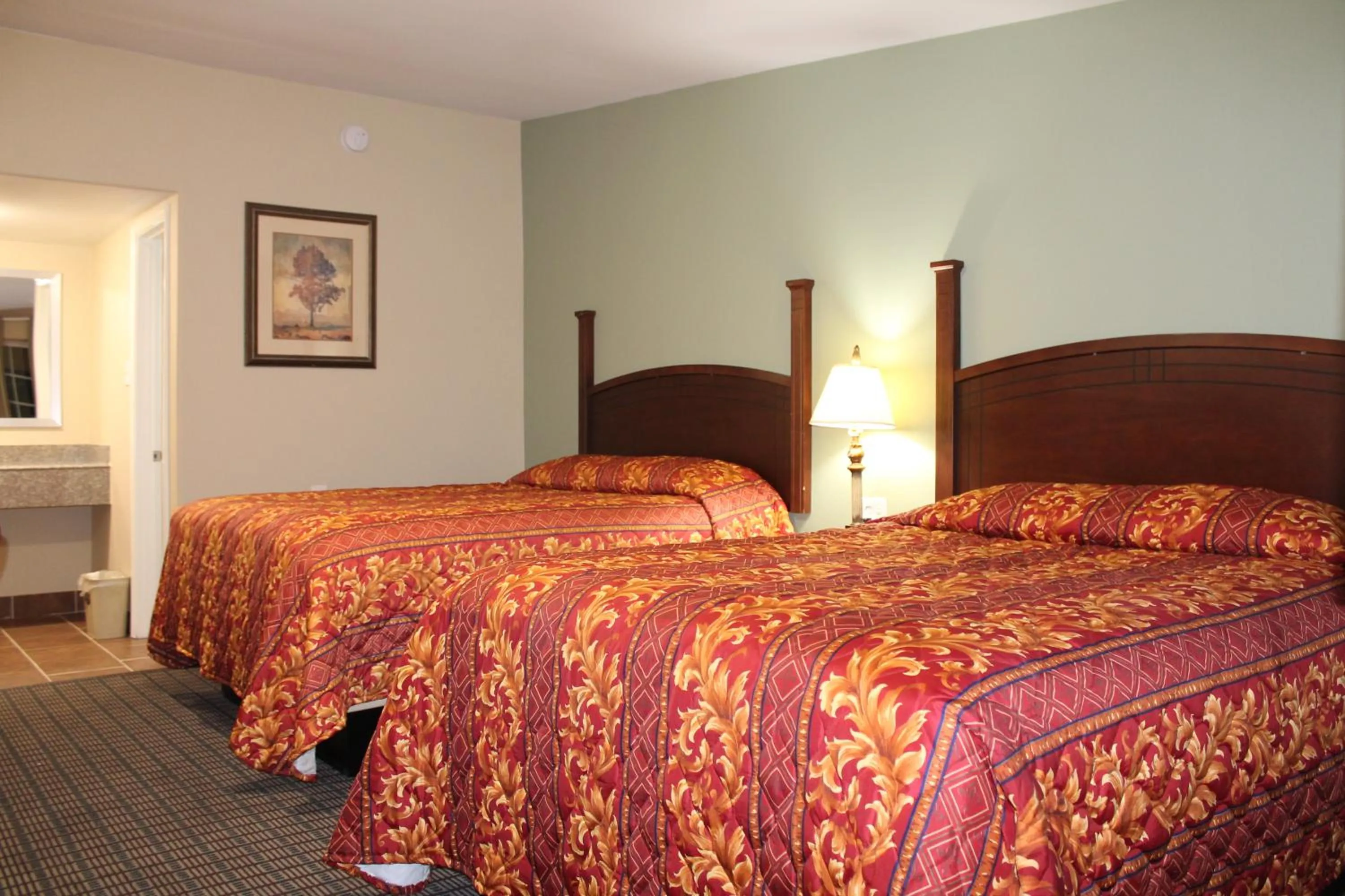 Bed in American Inn & Suites