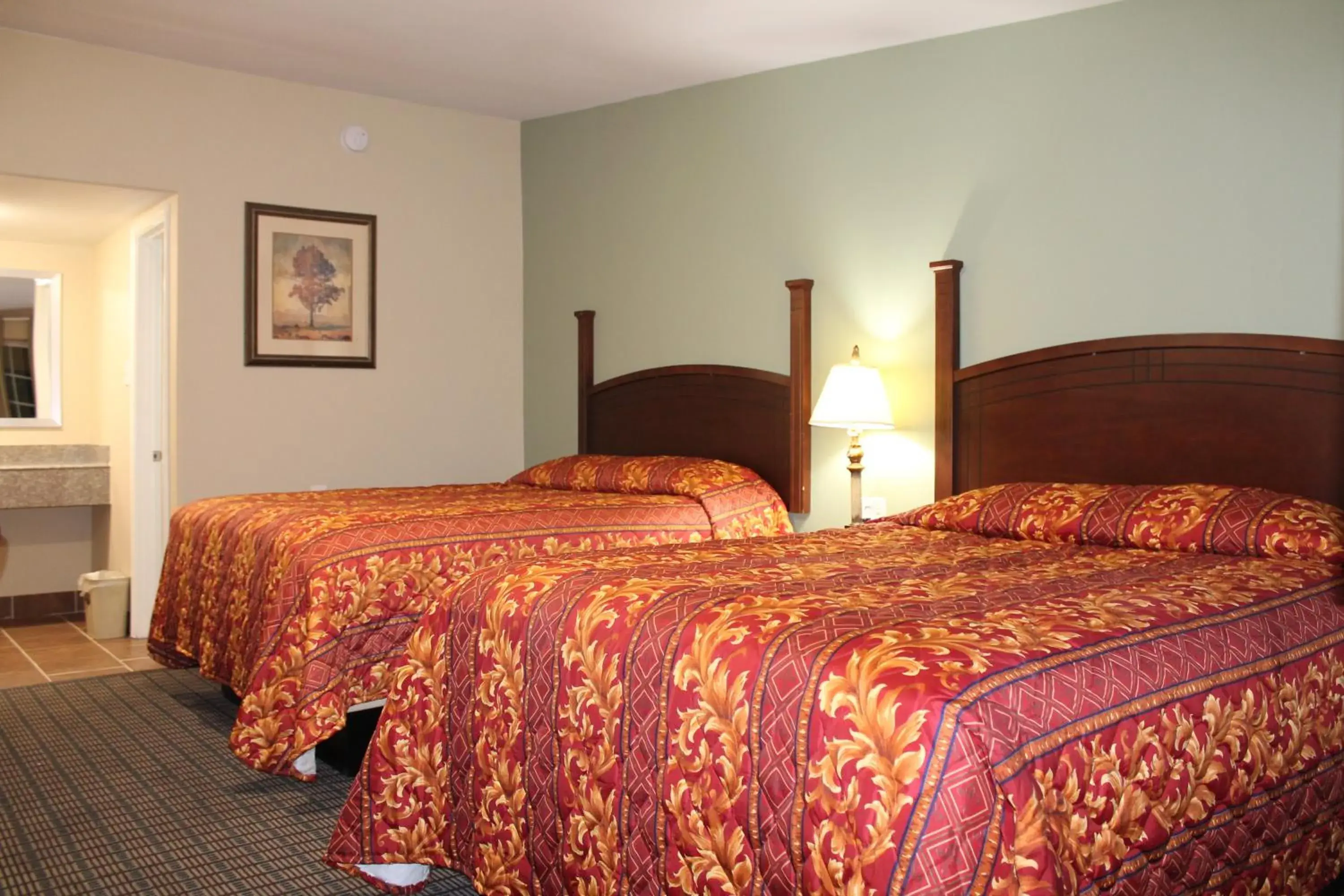 Bed in American Inn & Suites Bed in American Inn & Suites