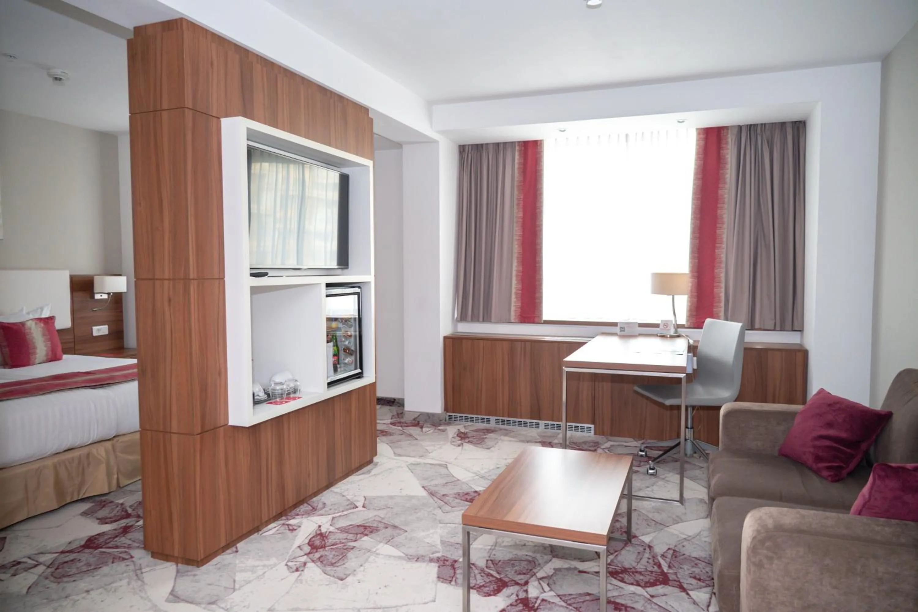 Seating area, Bed in Ramada Plaza by Wyndham Craiova