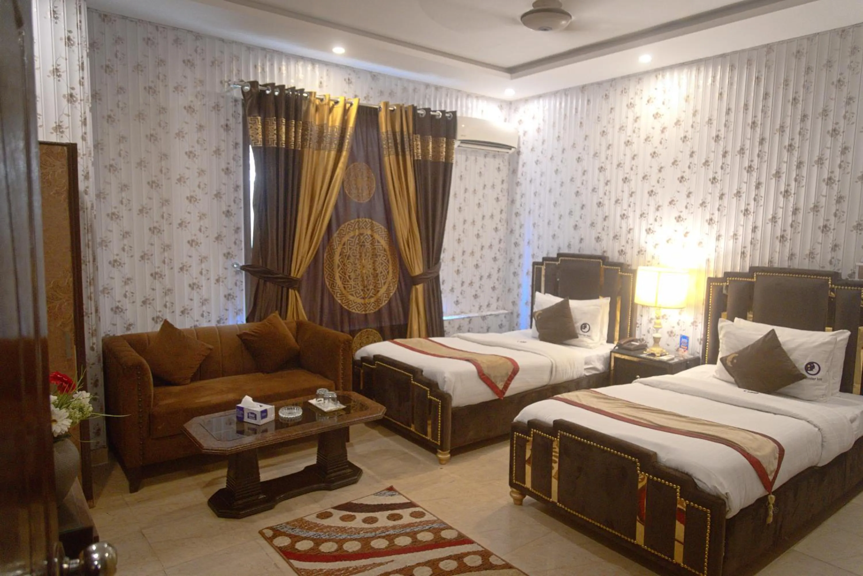 Seating area, Bed in Premier Inn Johar Town Lahore