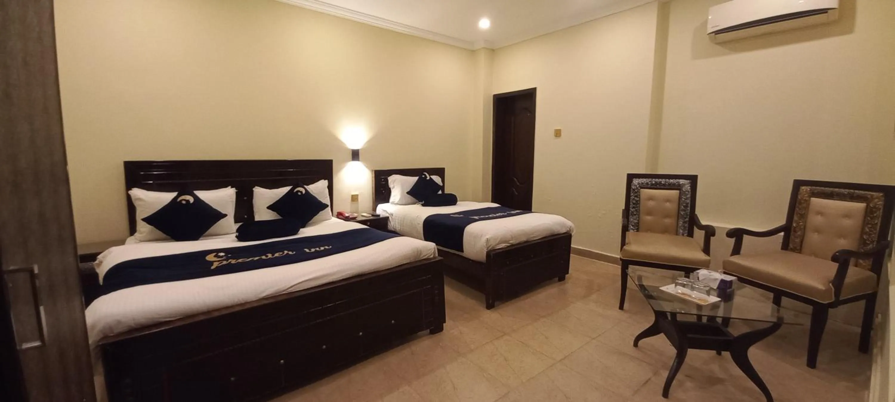 Seating area, Bed in Premier Inn Johar Town Lahore