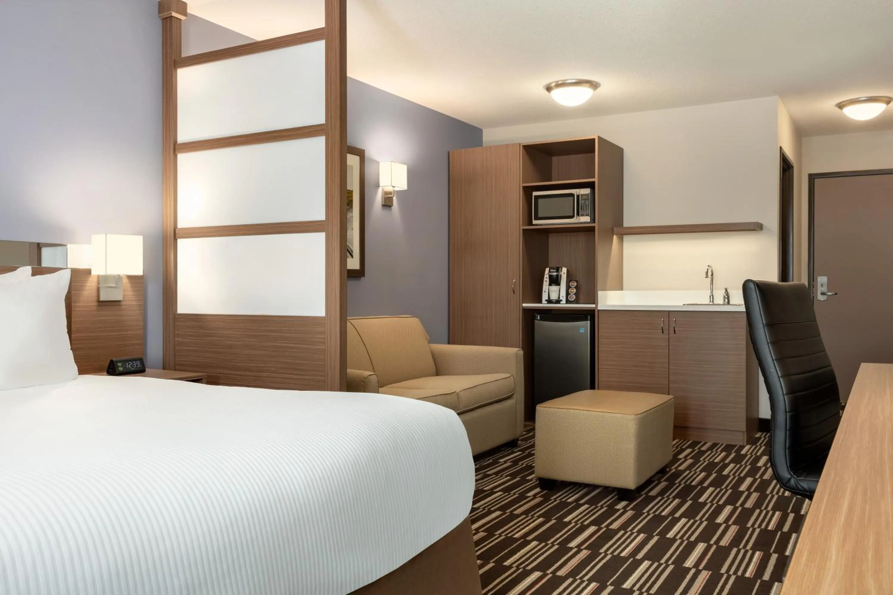 Seating area, Bed in Microtel Inn & Suites by Wyndham Bonnyville