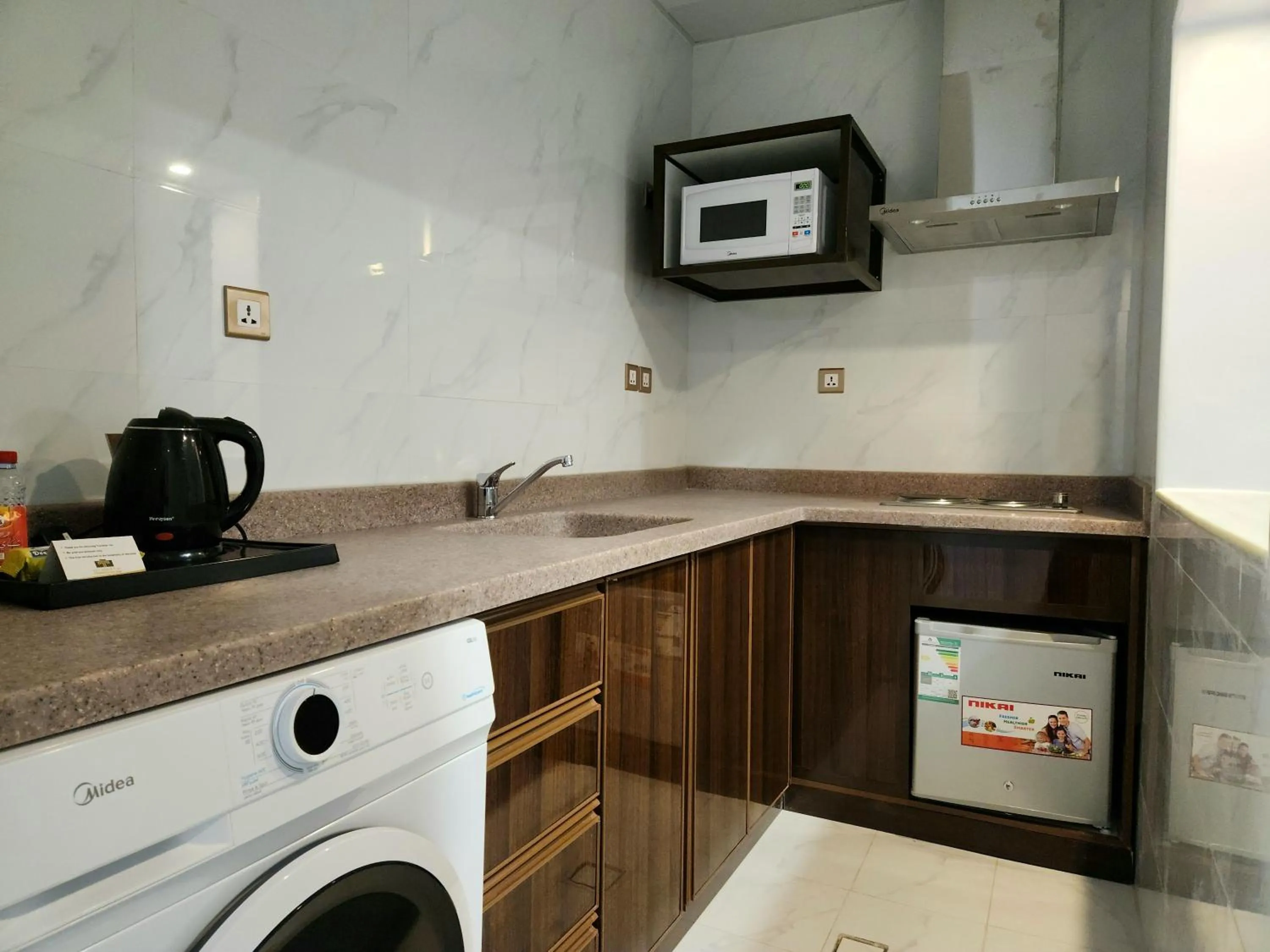 Kitchen or kitchenette in Travellerinn Serviced Apartment