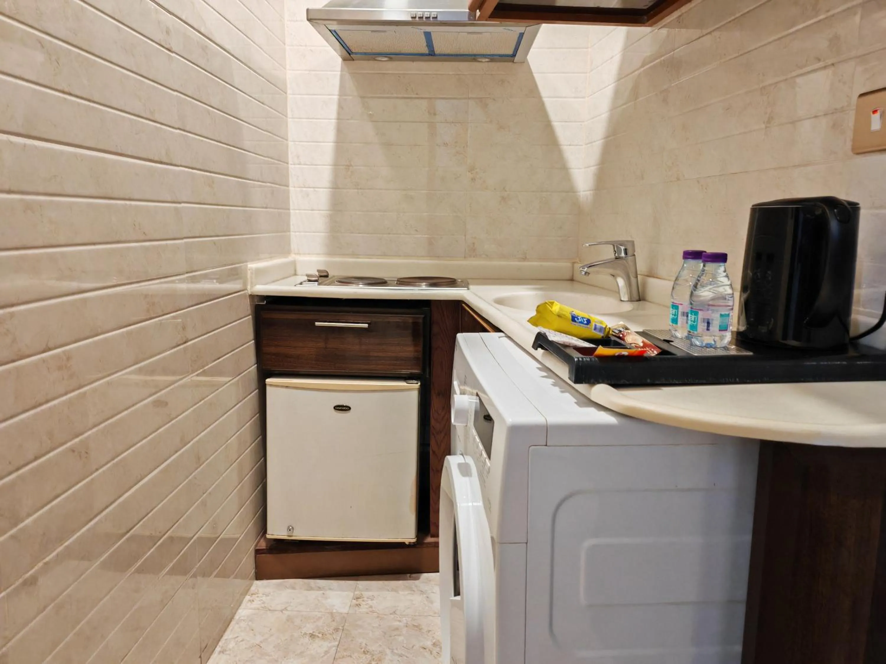 Kitchen or kitchenette in Travellerinn Serviced Apartment