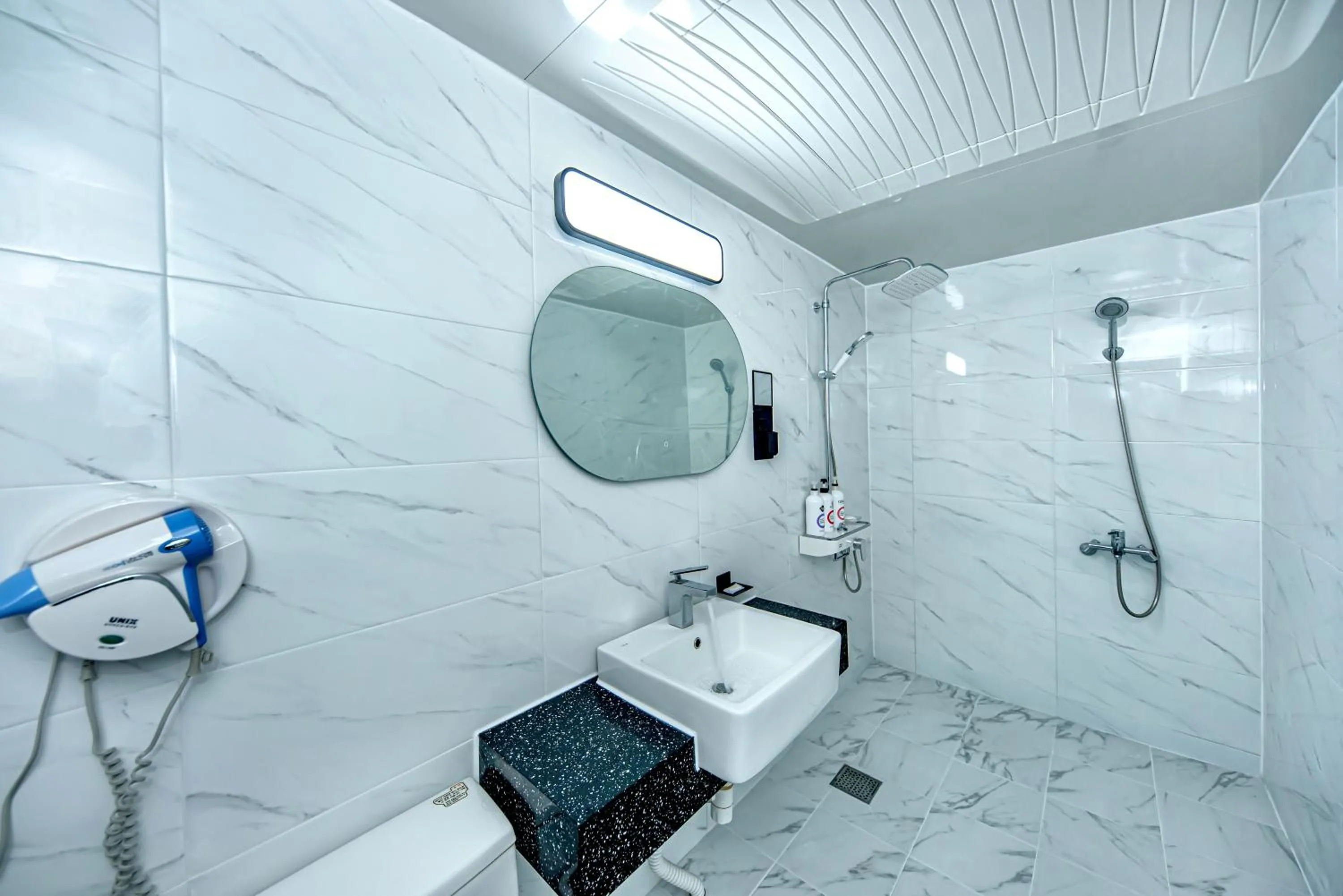 Bathroom in HS Tourist Hotel