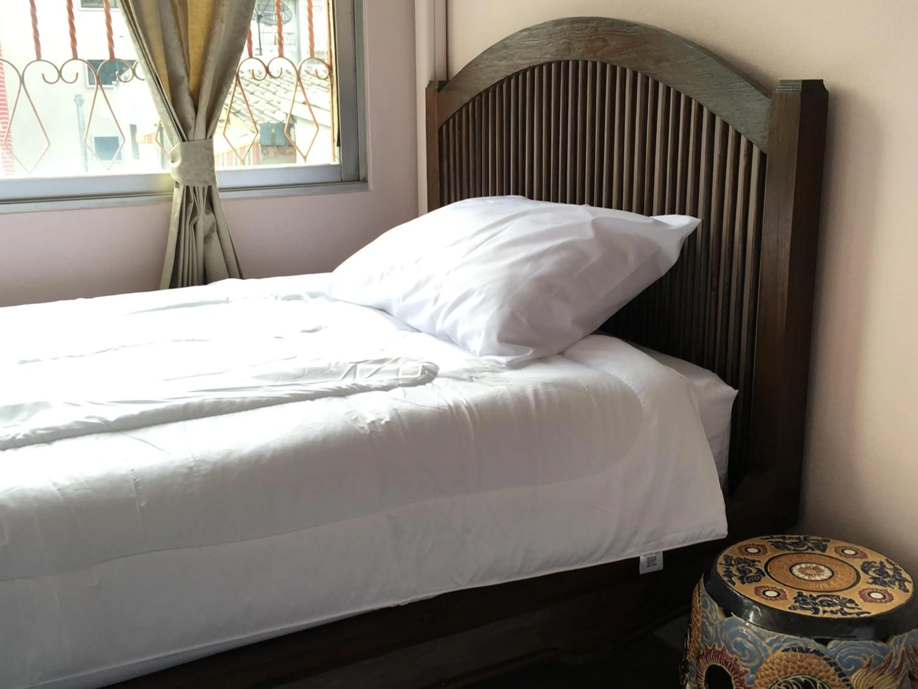 Bed in The Grand Palace Hotel