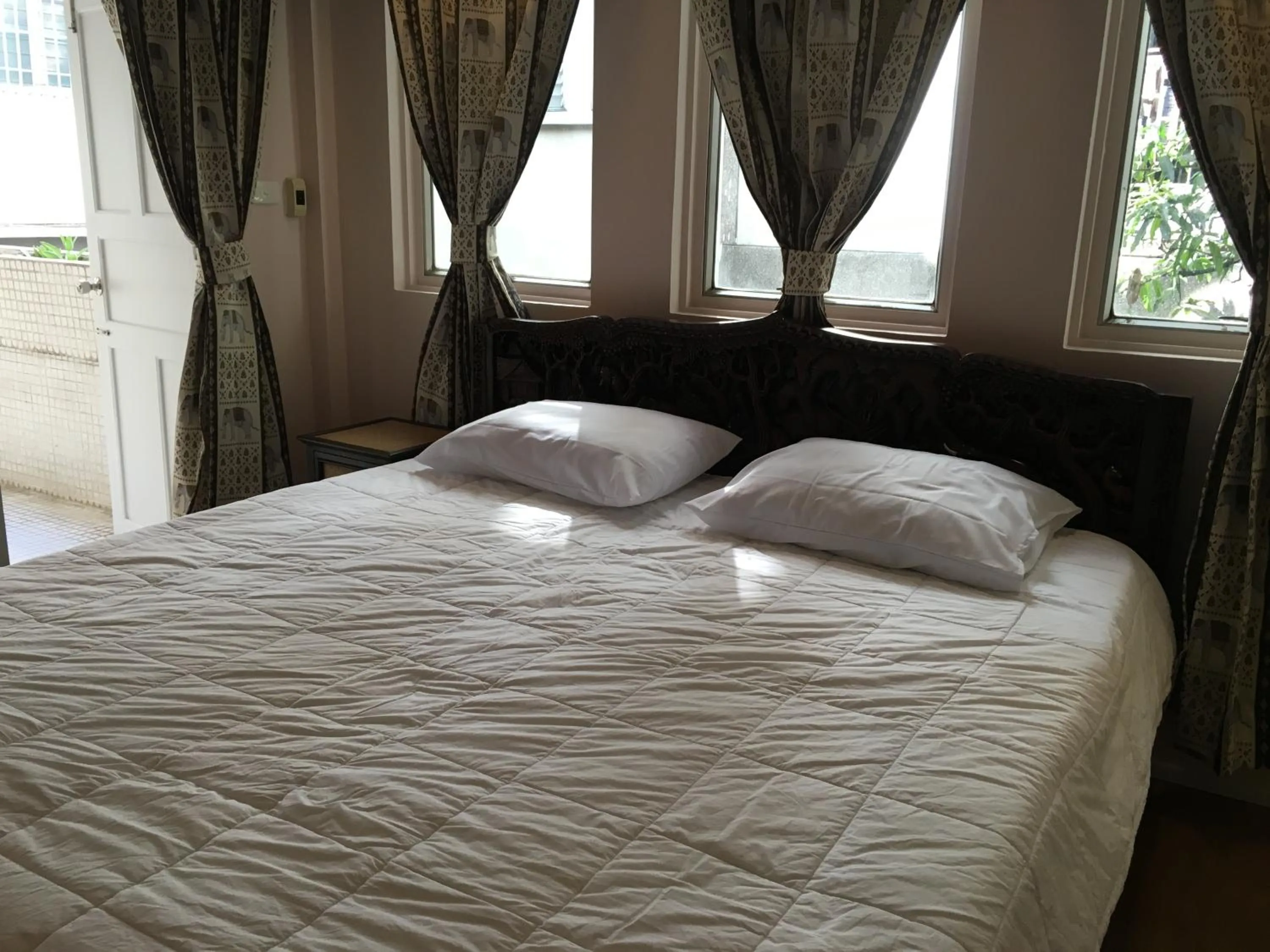 Bed in The Grand Palace Hotel