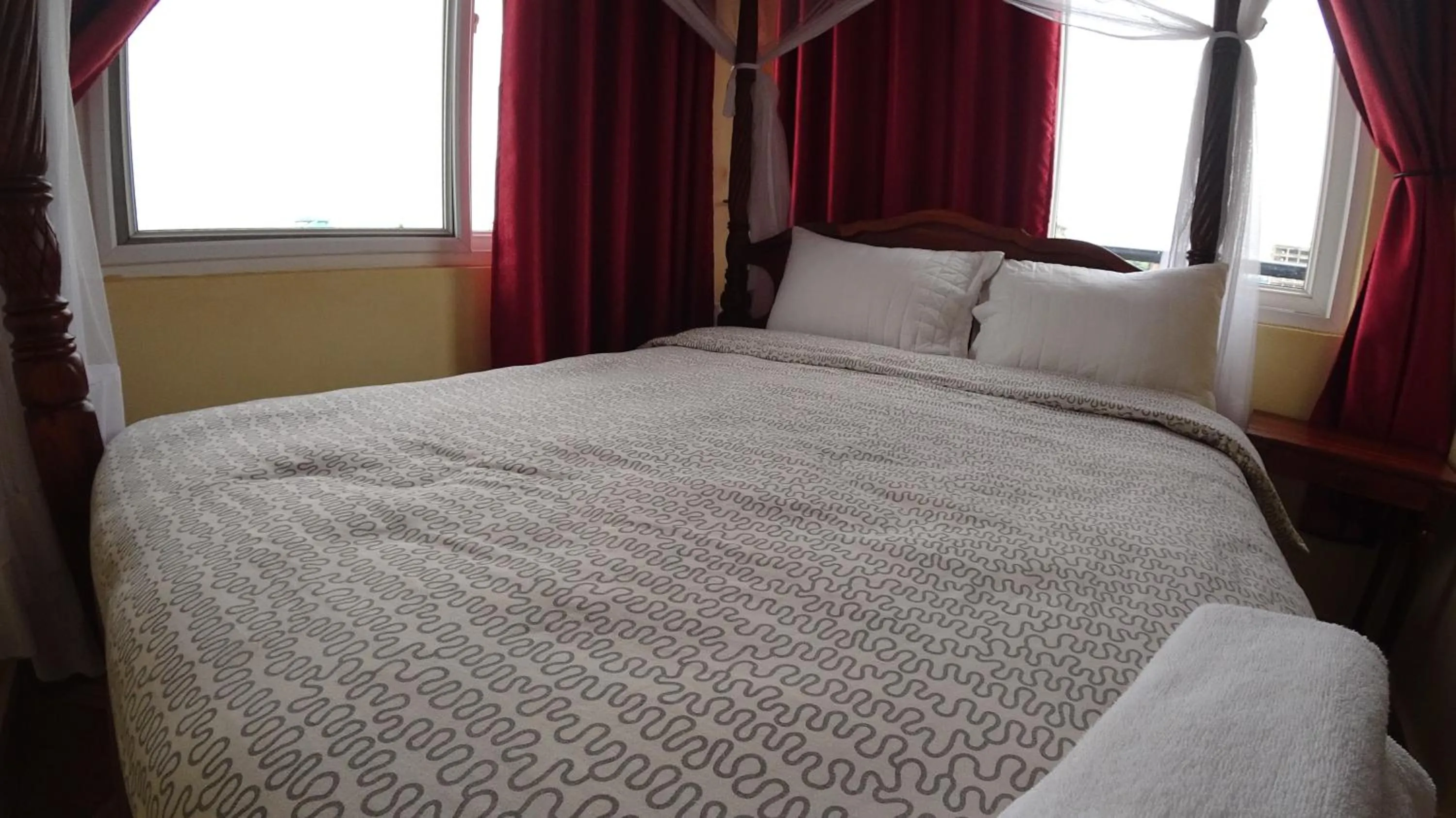 Bed in East Point Hotel Moshi