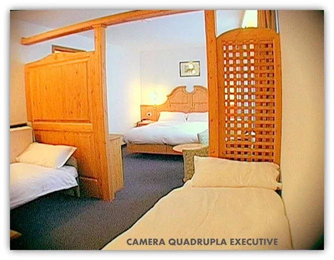 Bed in Hotel Beau Sejour