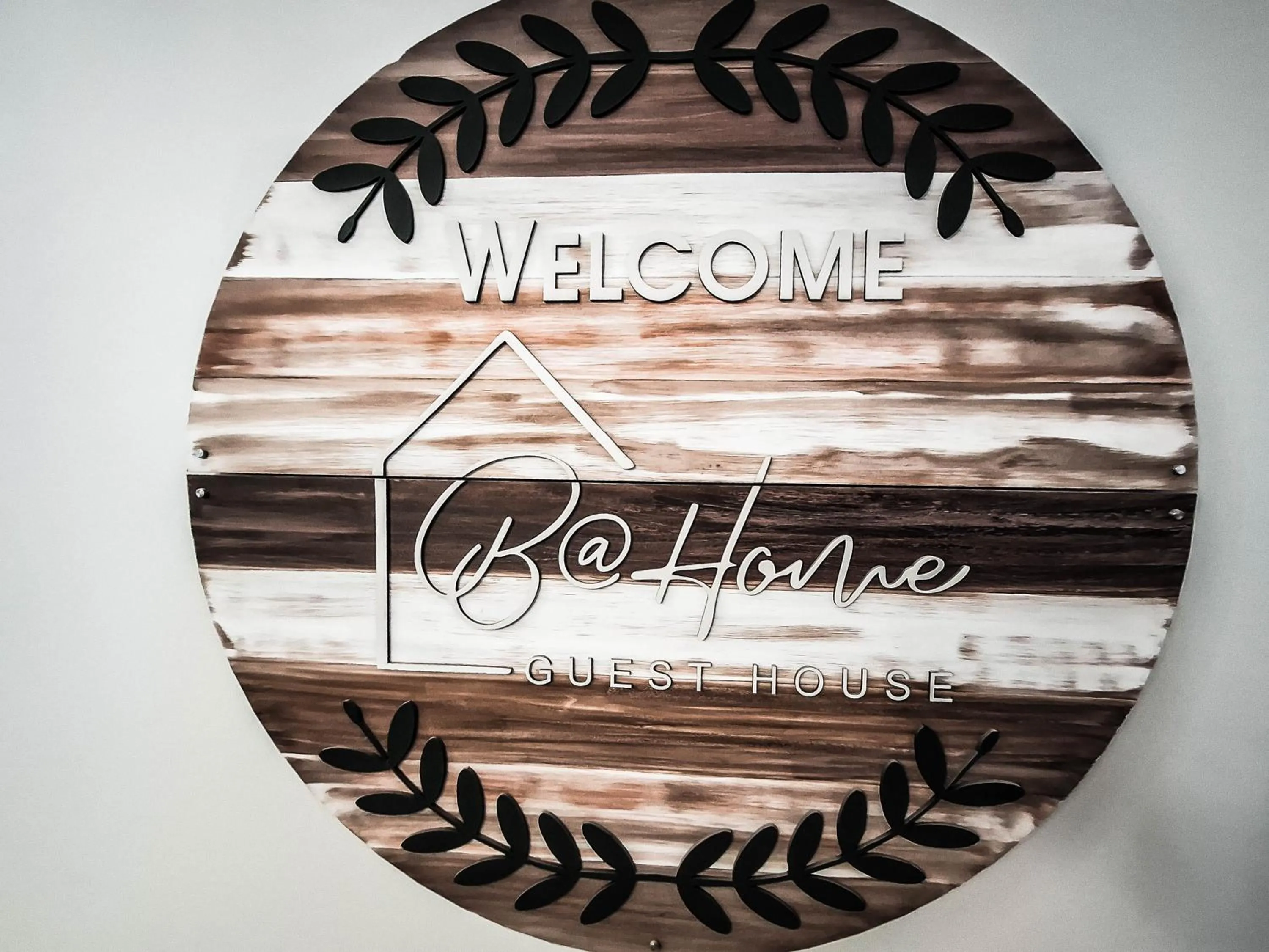 Property logo or sign in B at Home Guest House