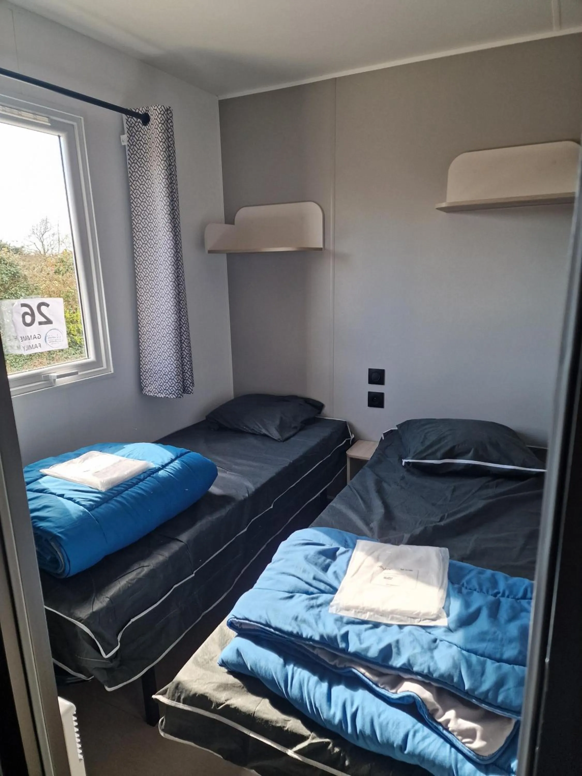 Bed in Camping Les P'tites Maisons dans la Prairie