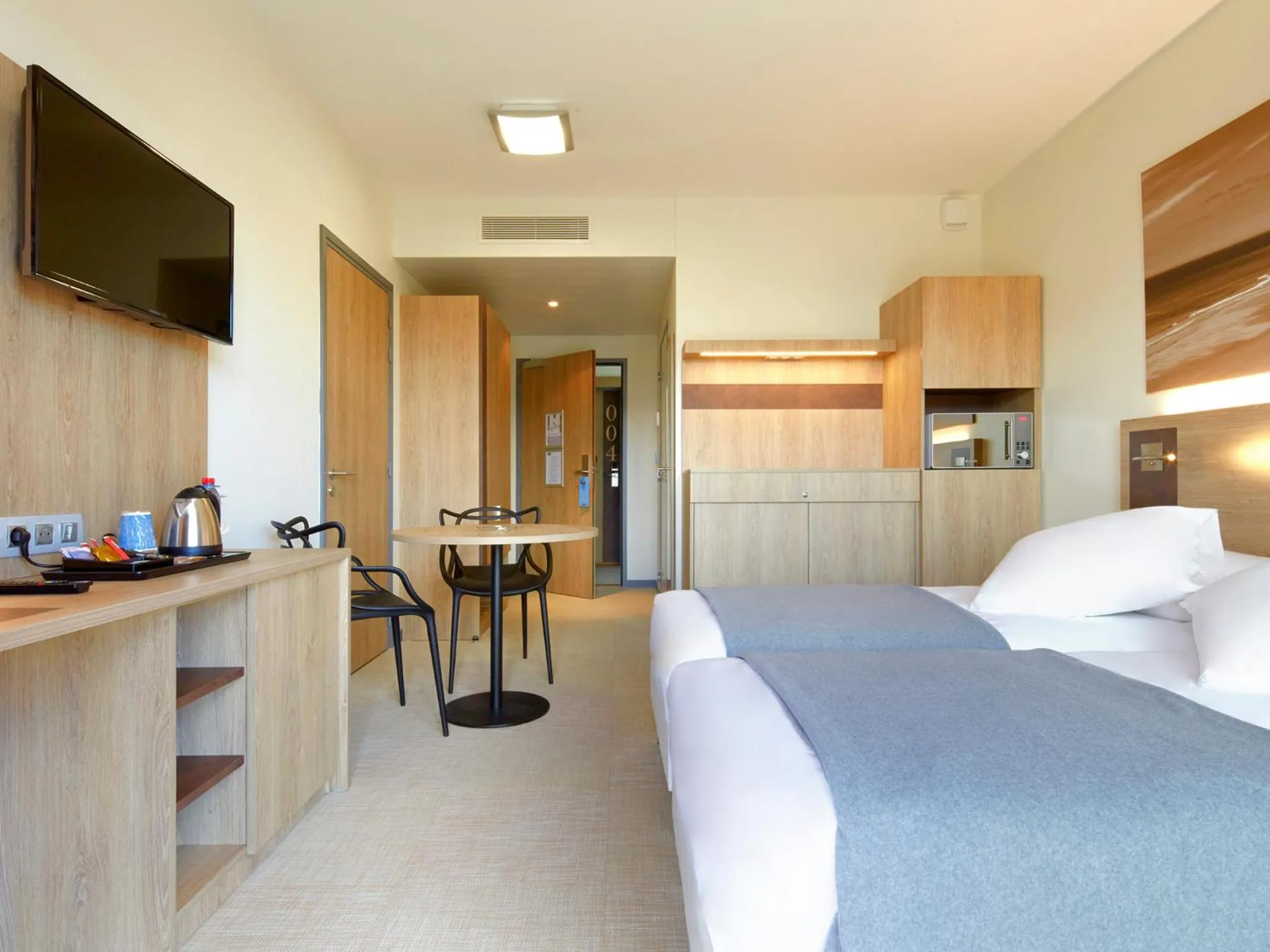 Bed in Kyriad Prestige Residence & Spa Cabourg-Dives-sur-Mer