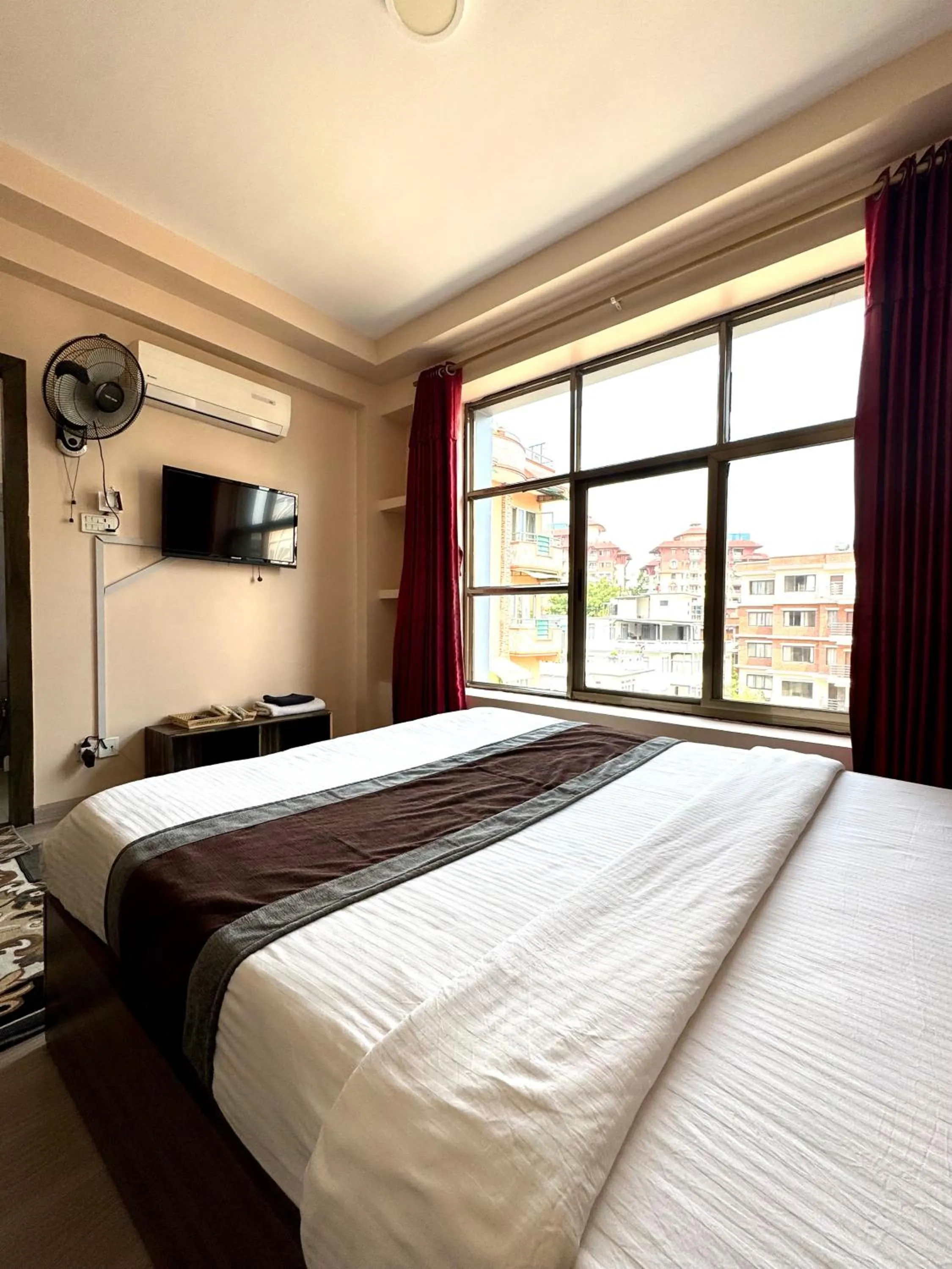 Bed in Three Brothers Apartment and Hotel