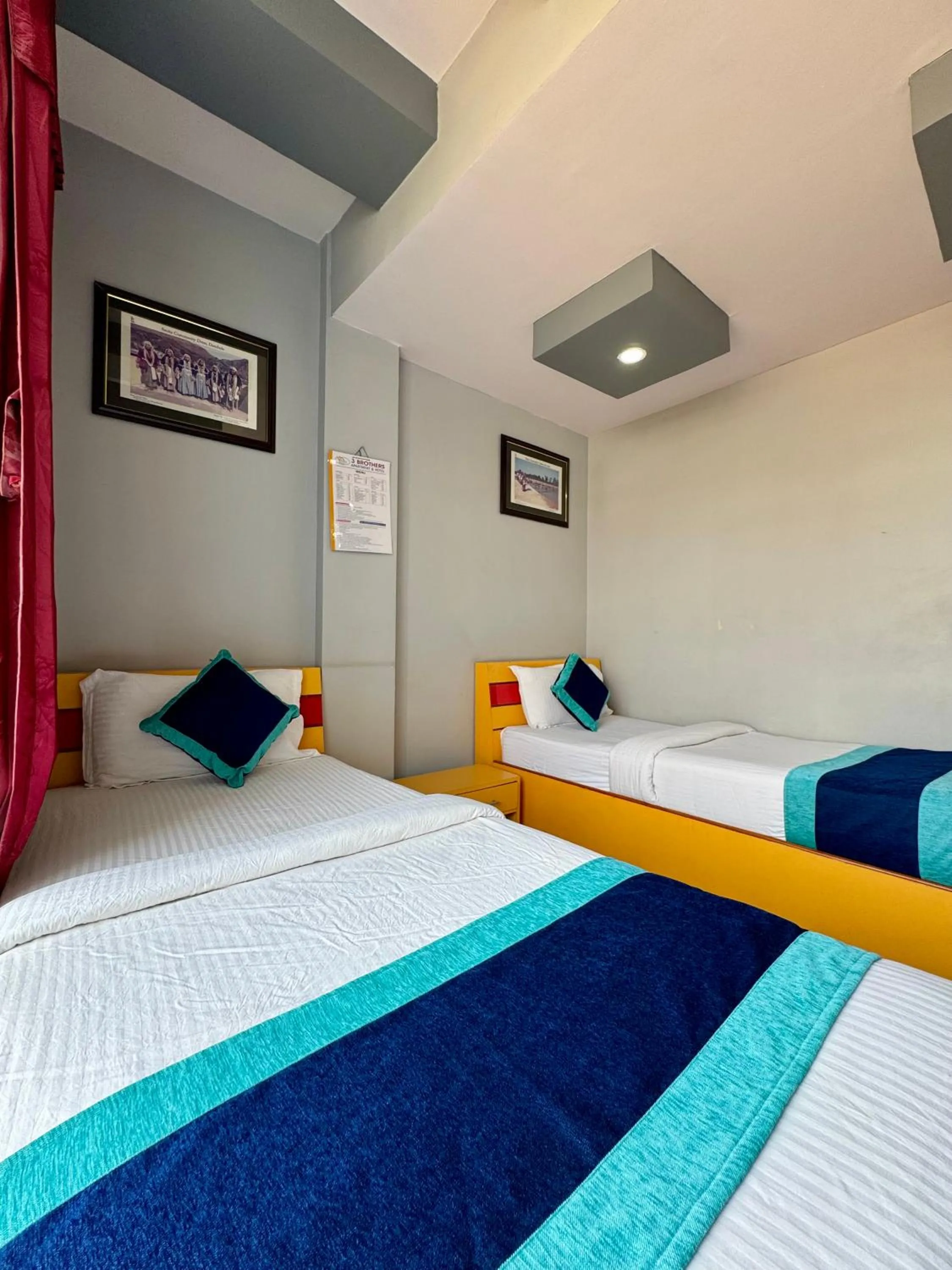 Bed in Three Brothers Apartment and Hotel