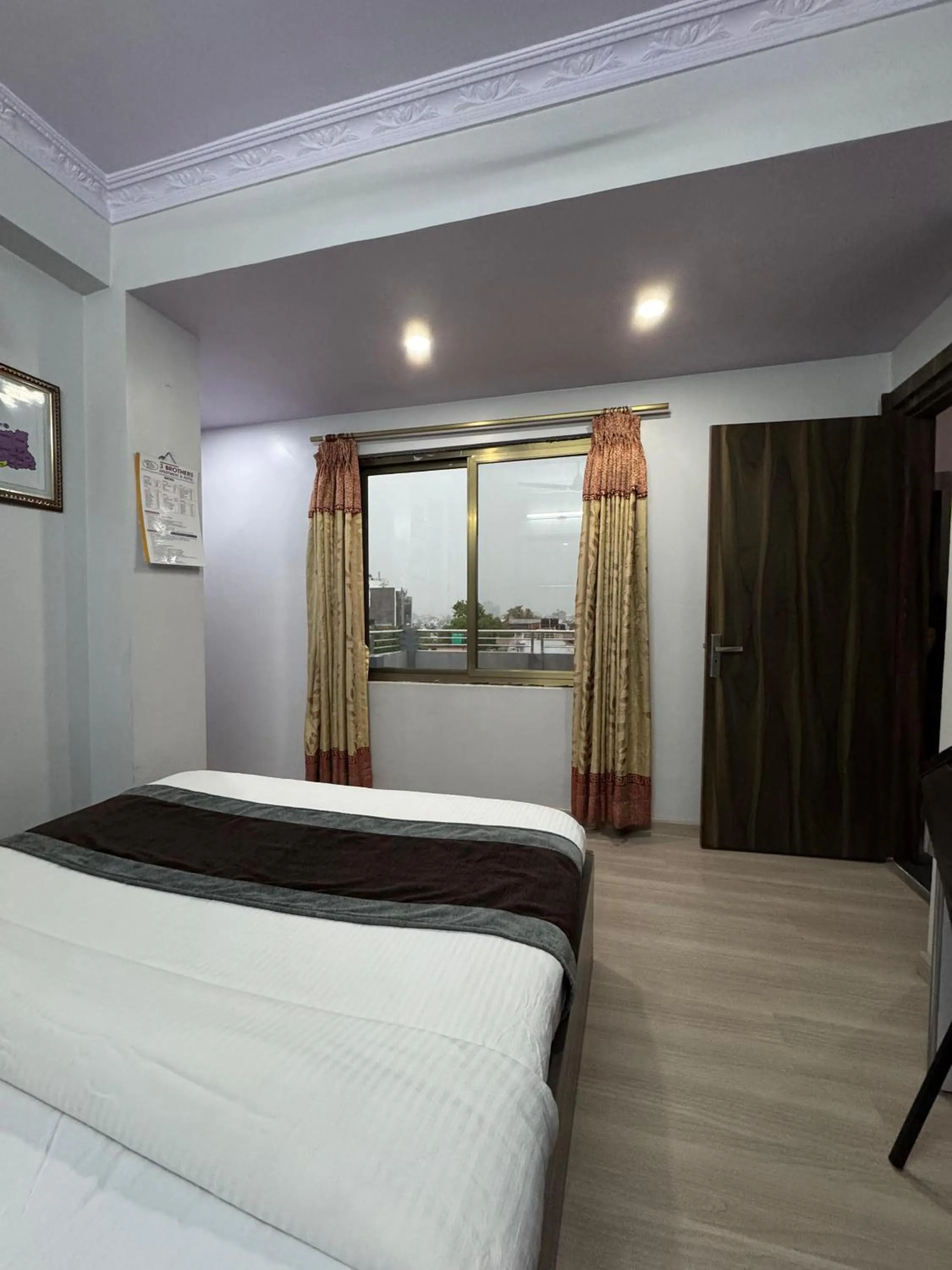 Bed in Three Brothers Apartment and Hotel