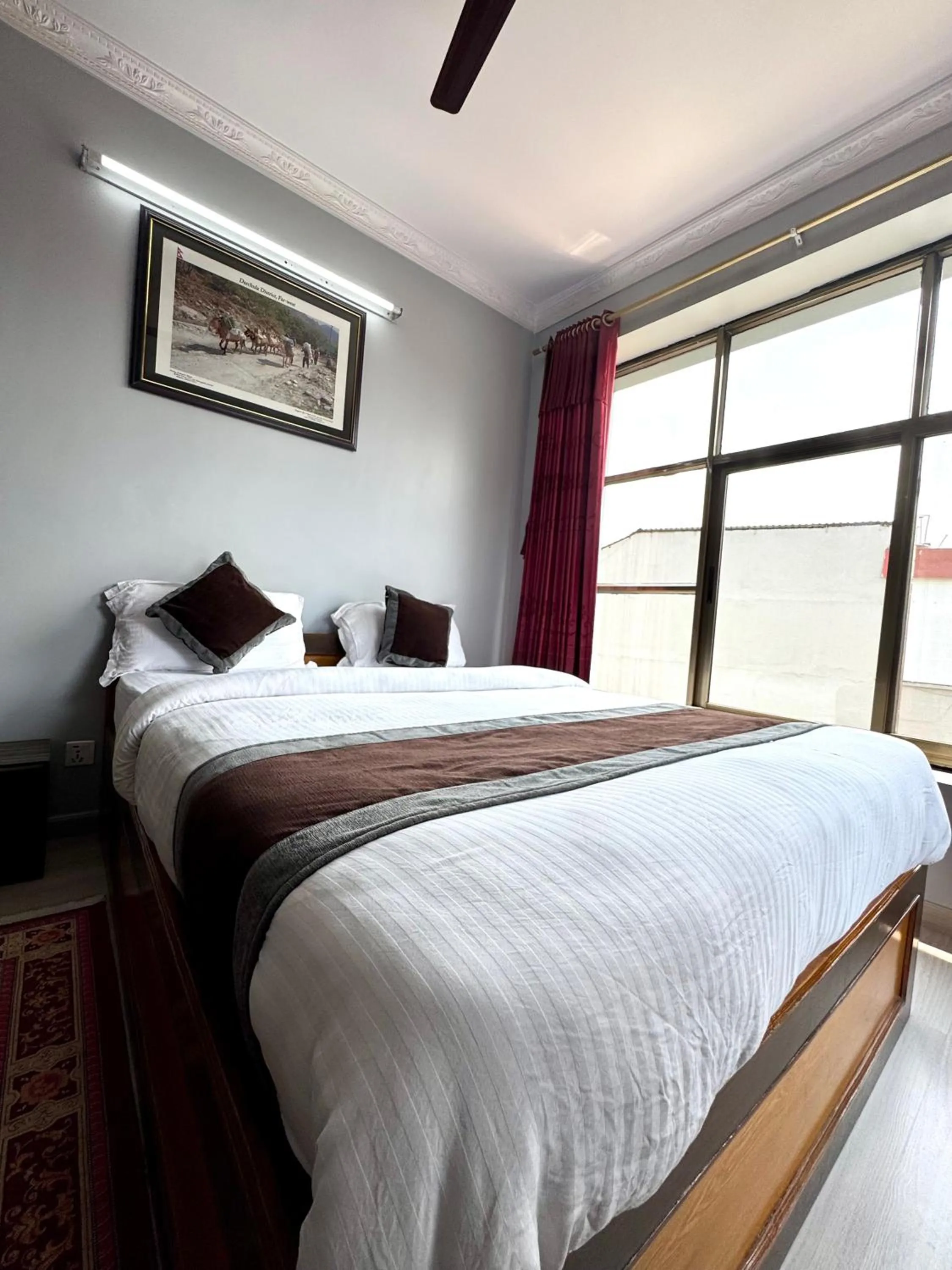 Bed in Three Brothers Apartment and Hotel