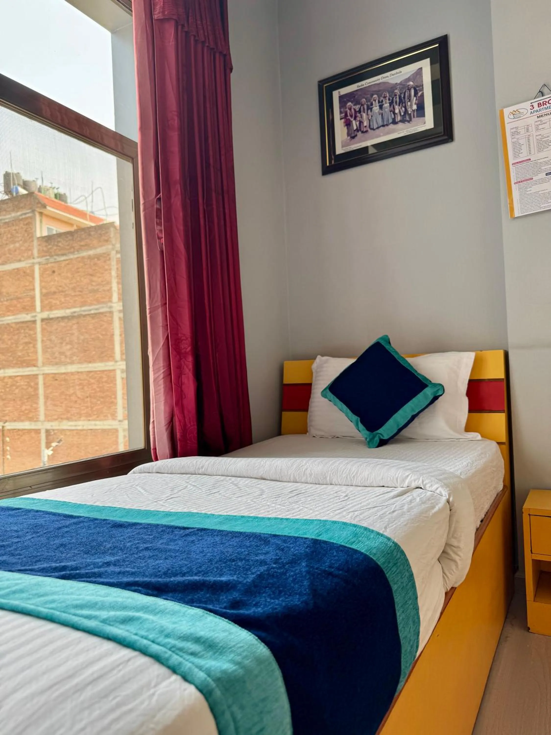 Bed in Three Brothers Apartment and Hotel