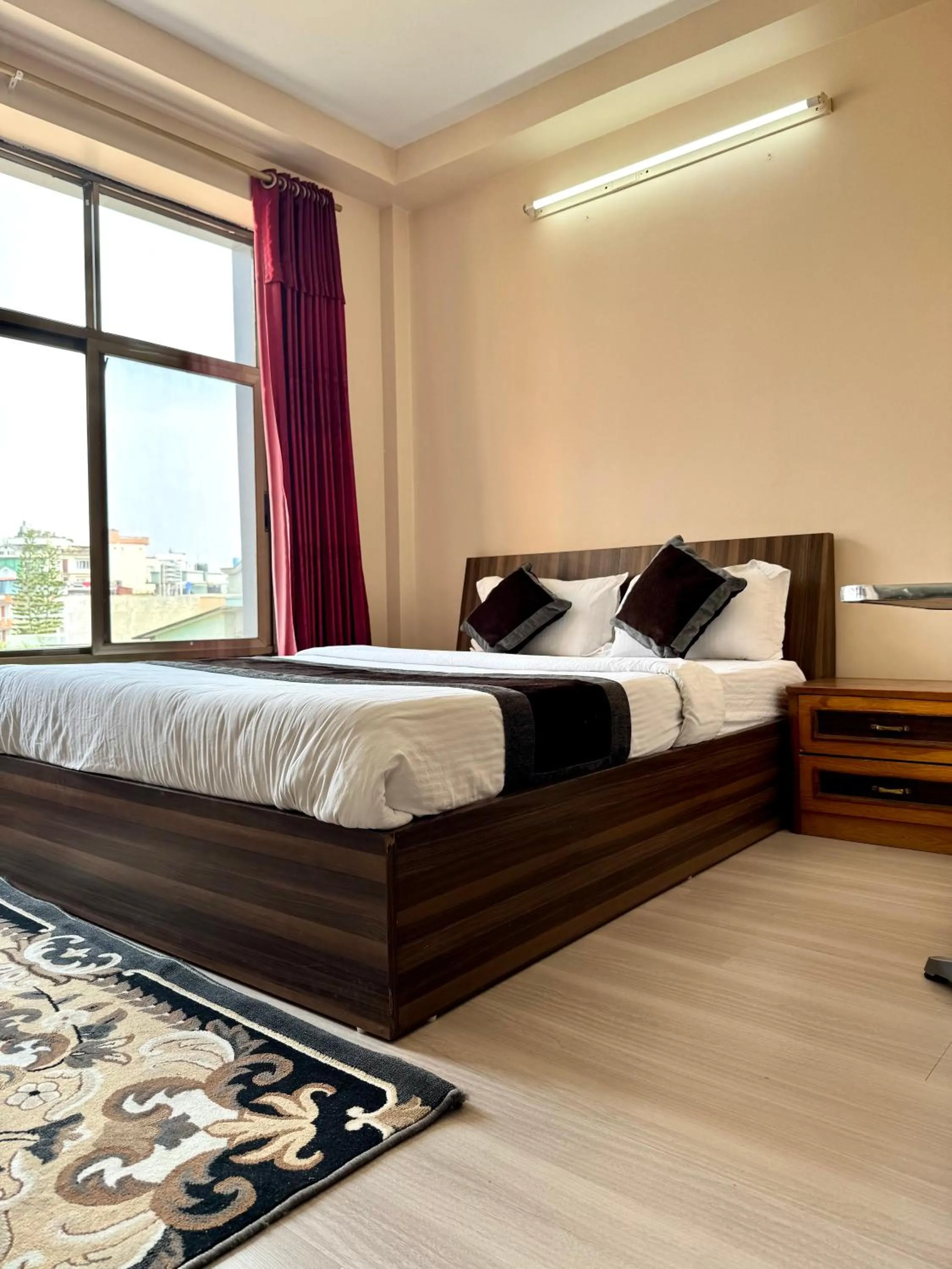Bed in Three Brothers Apartment and Hotel