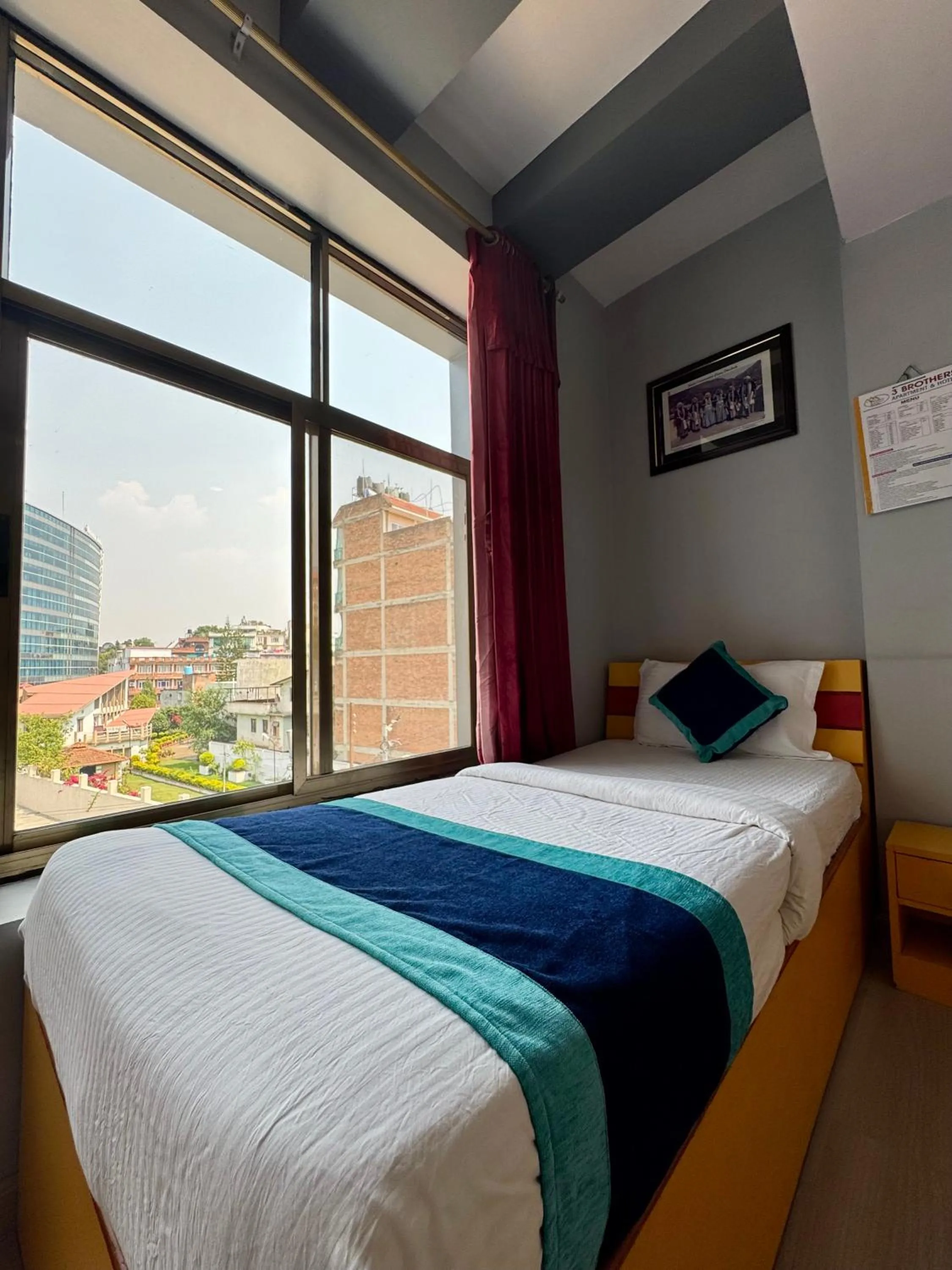 Bed in Three Brothers Apartment and Hotel
