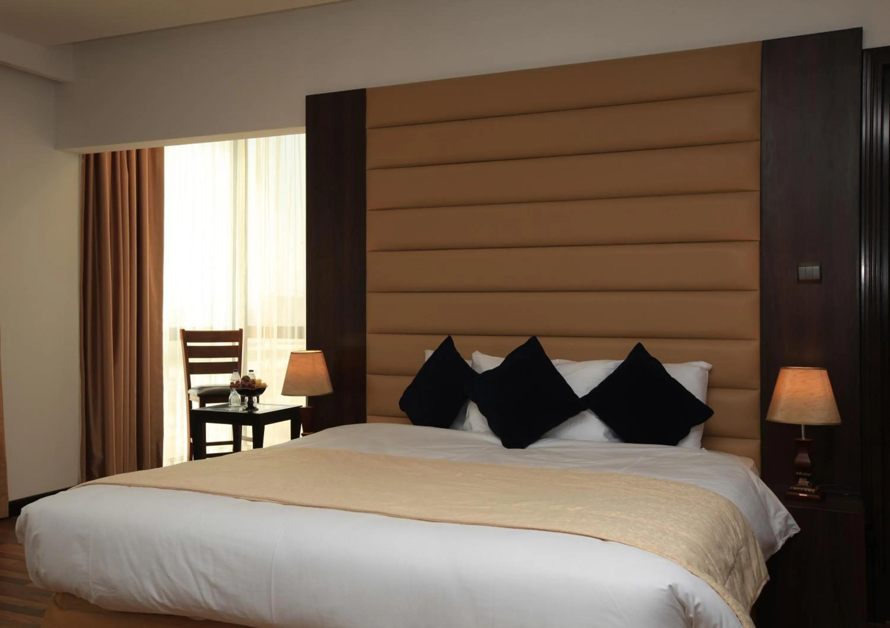 Bed in Golden Tulip Al Khobar Suites