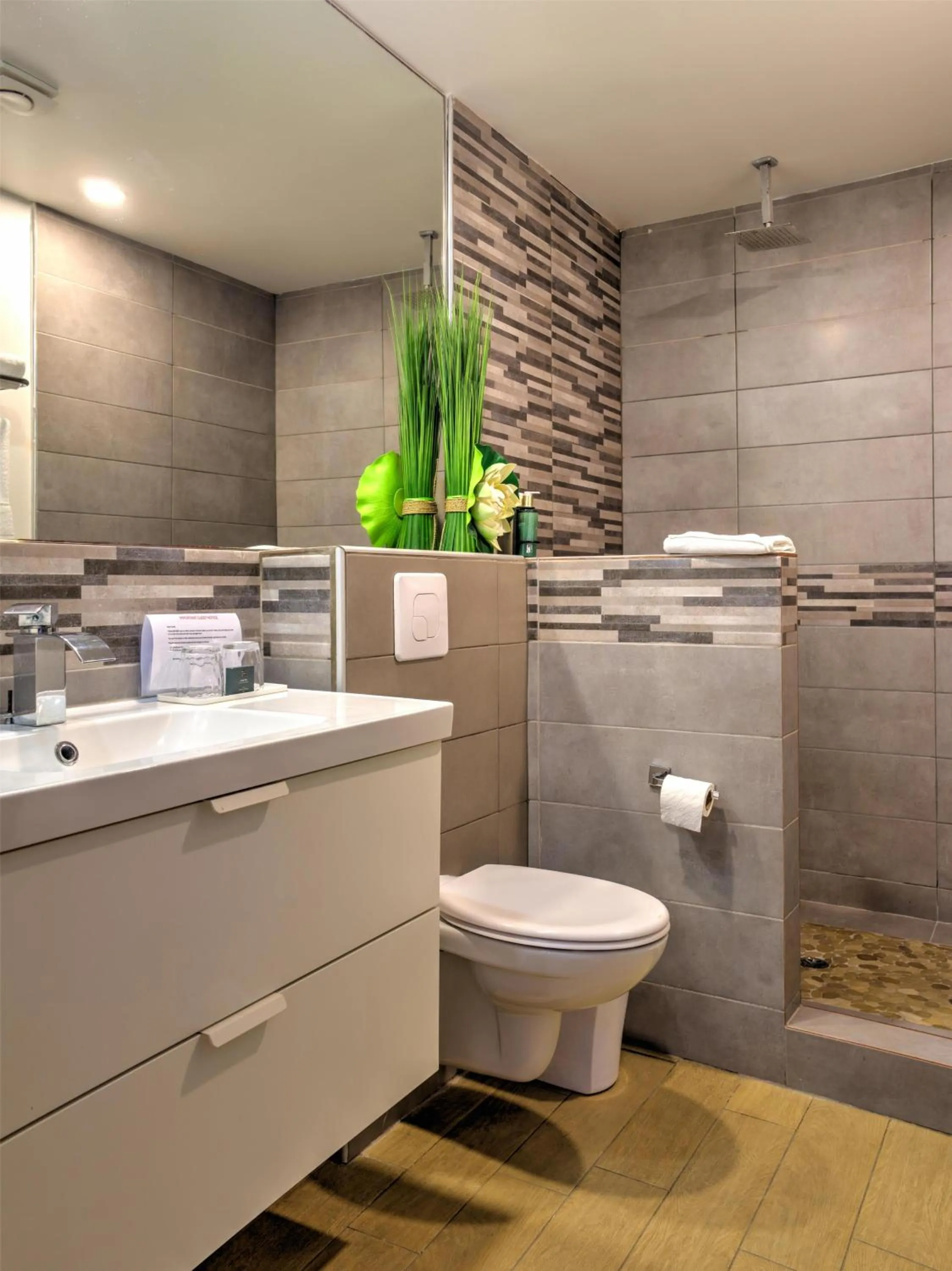 Bathroom in Commodore Suites, SureStay Collection by Best Western