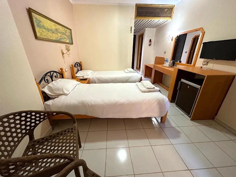 Bed in Gaddis Hotel, Suites and Apartments