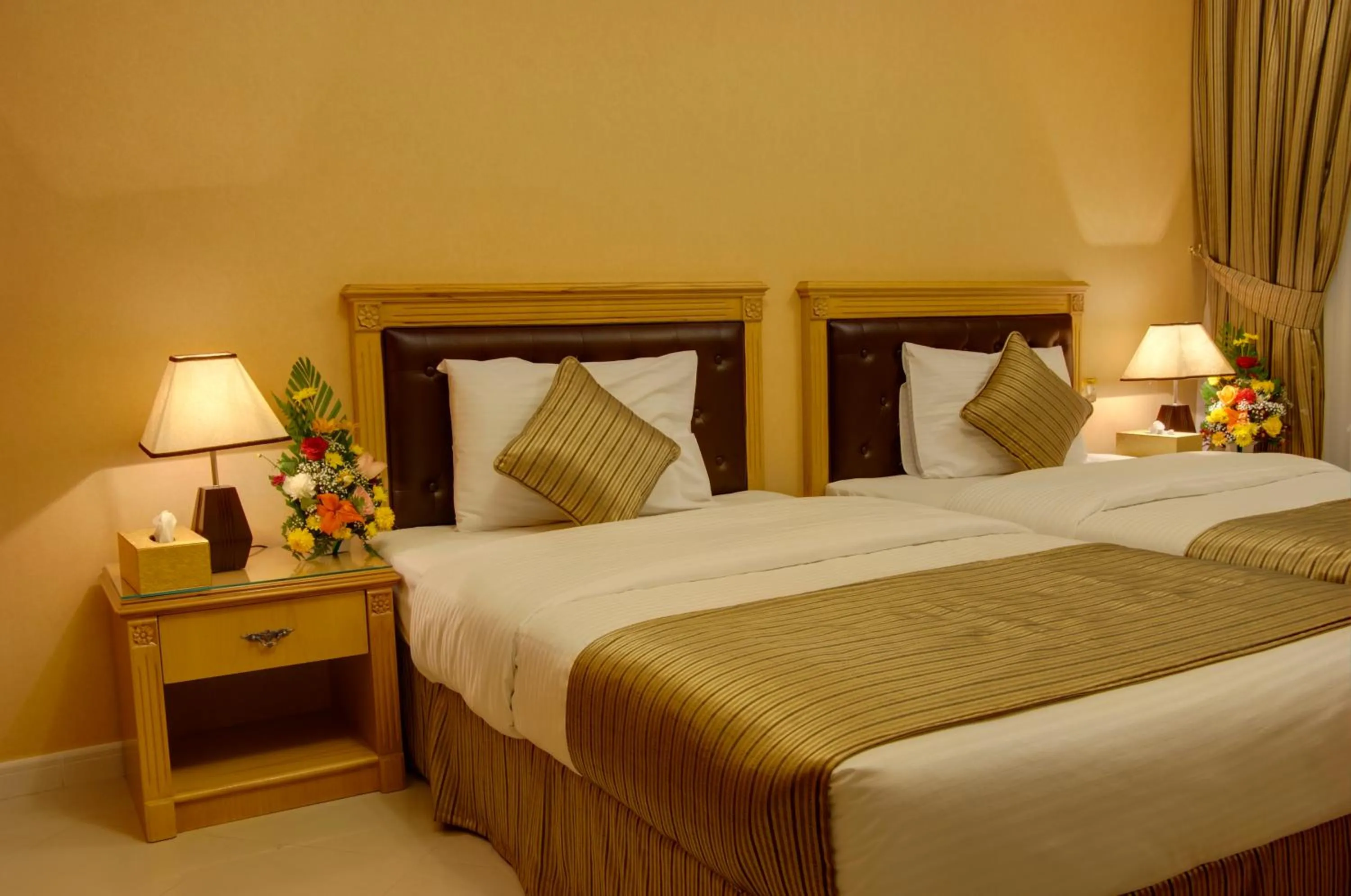 Bed in Deira Suites Deluxe Hotel Suites