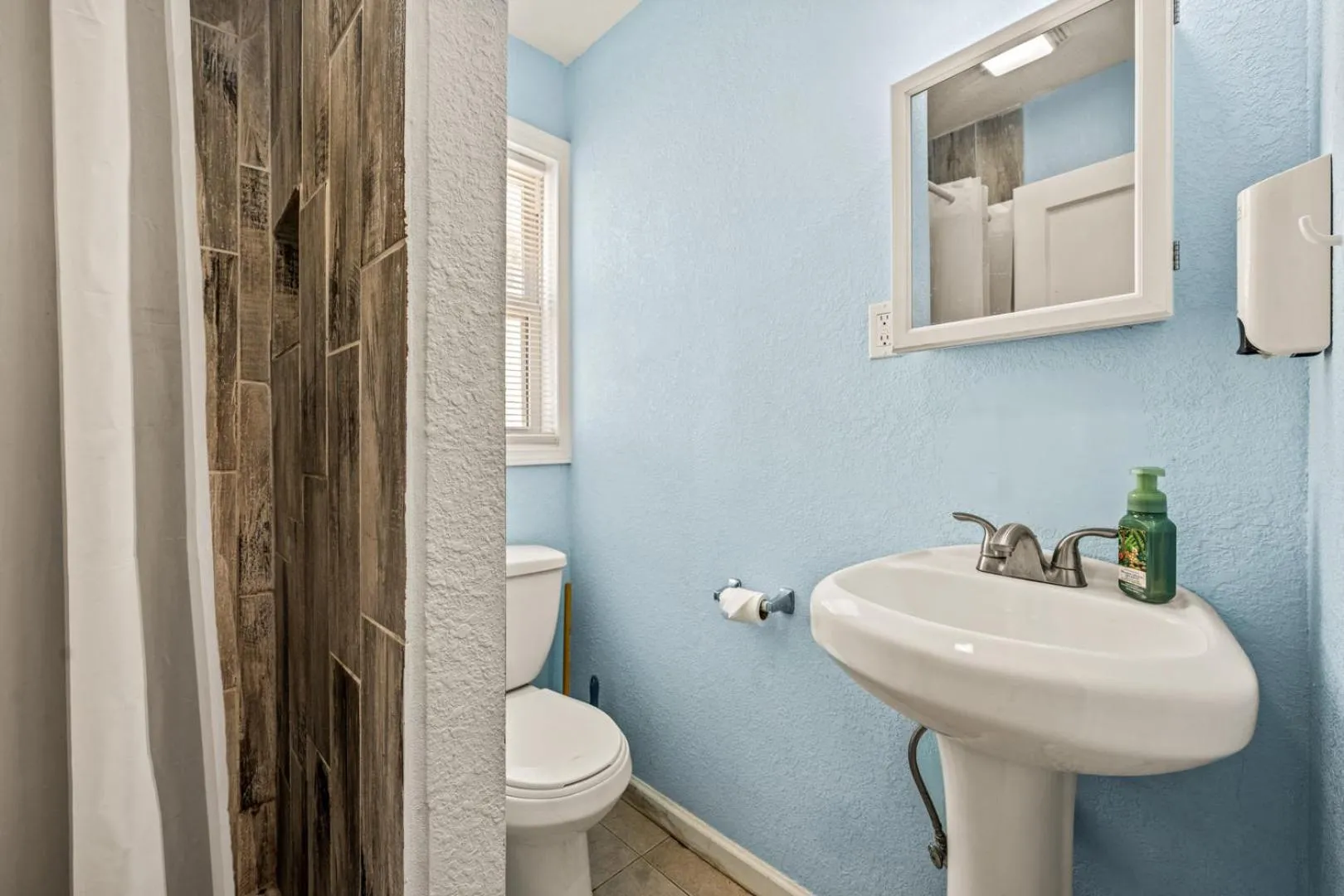 Toilet in Oceanside Court by KEES Vacations