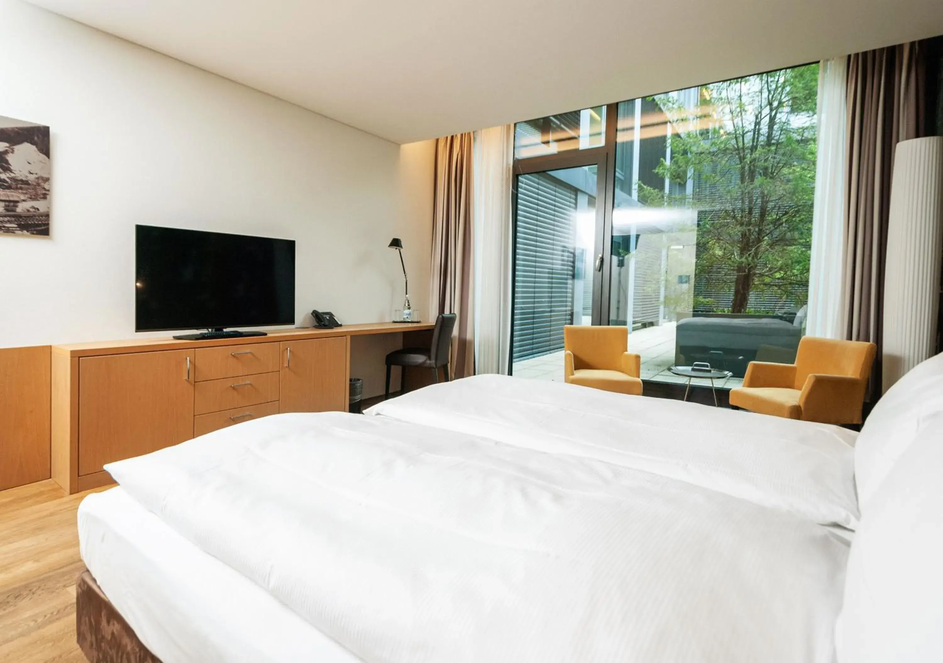 Seating area, Bed in Tailormade Hotel SIHLPARK Schindellegi Seating area, Bed in Tailormade Hotel SIHLPARK Schindellegi