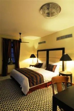 Bed in The Library Hotel Wellness Retreat