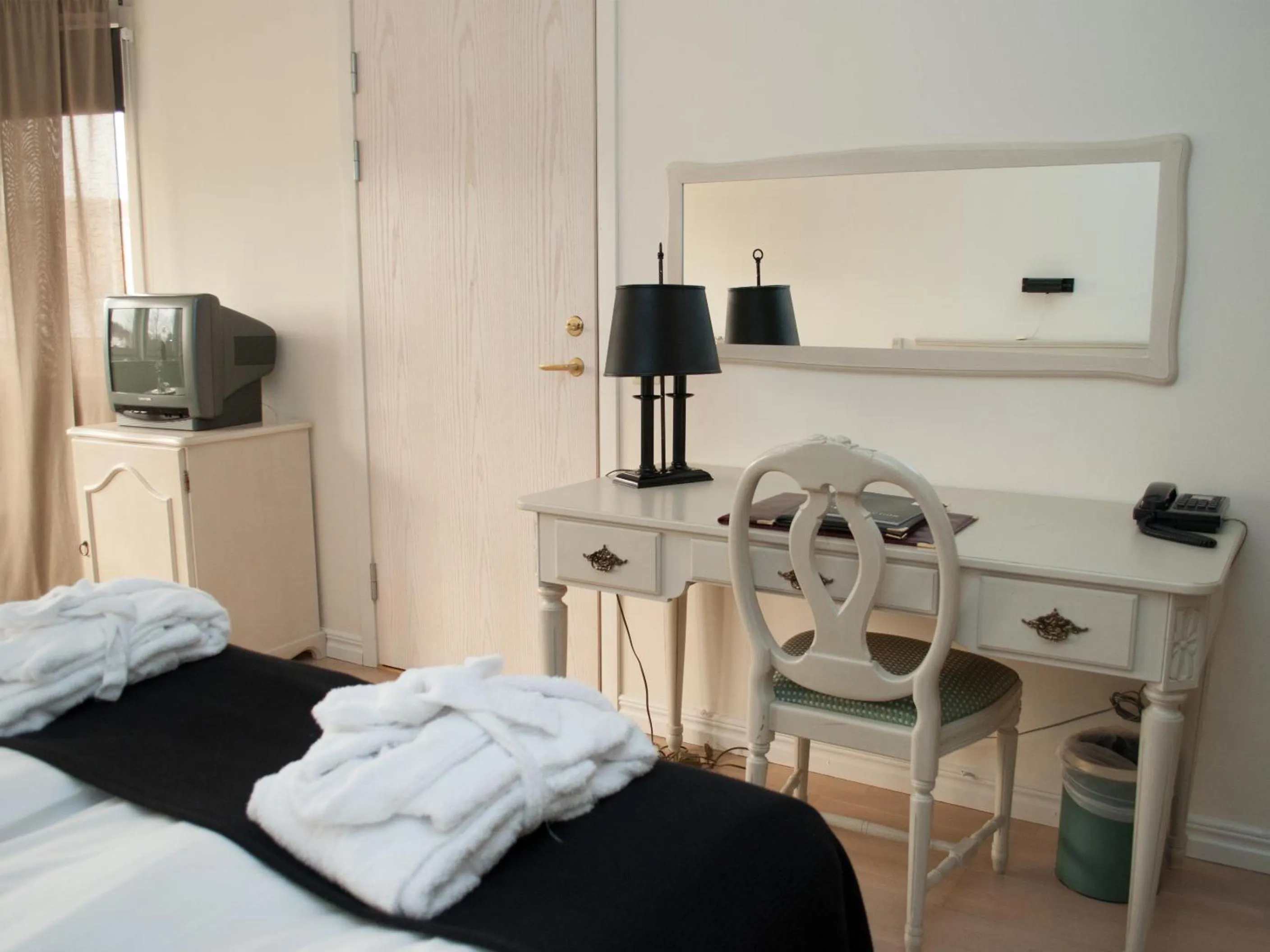 Seating area, Bed in First Hotel Olofström