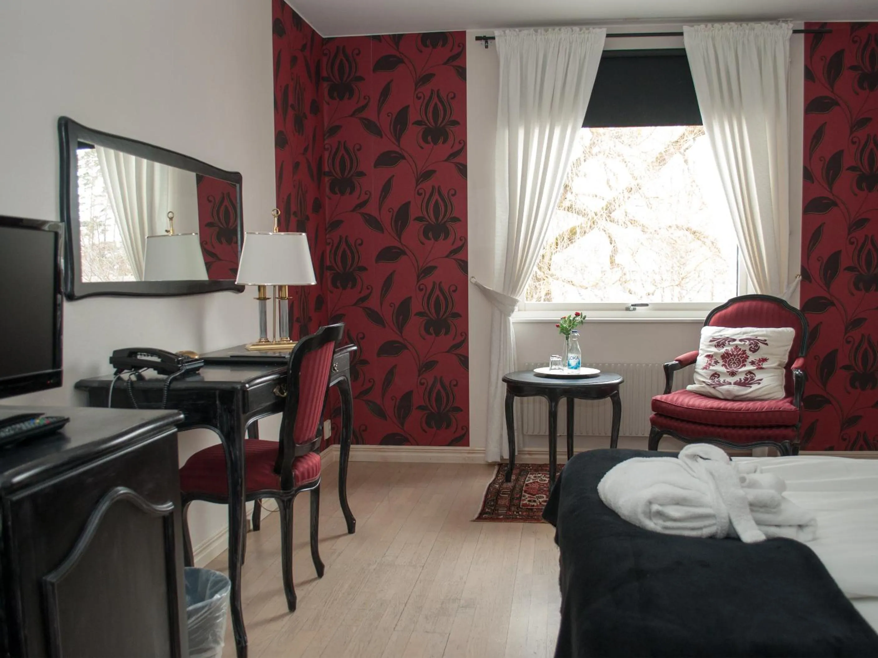 Seating area, Bed in First Hotel Olofström