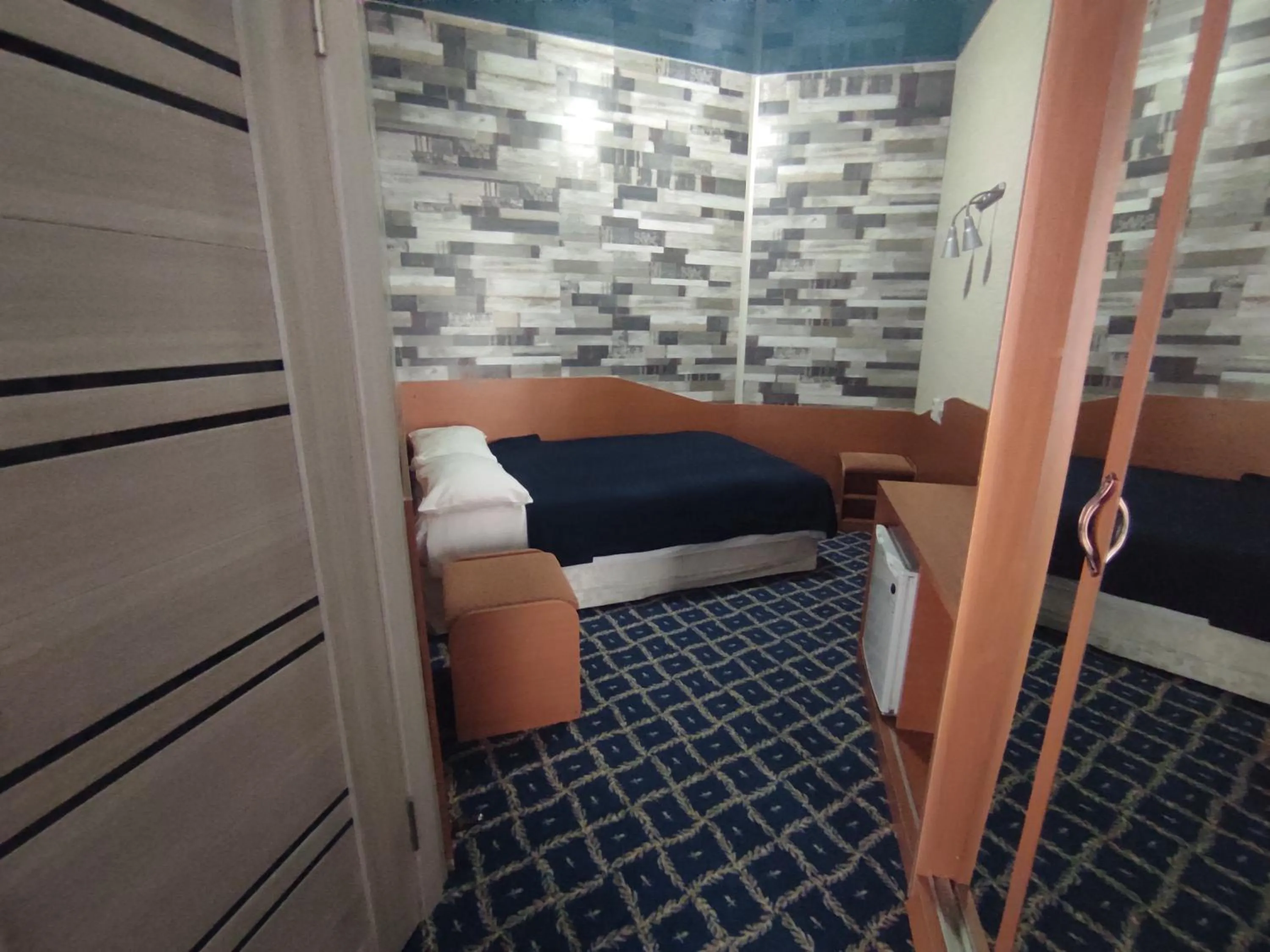 Bed in Three Dolphins Hotel