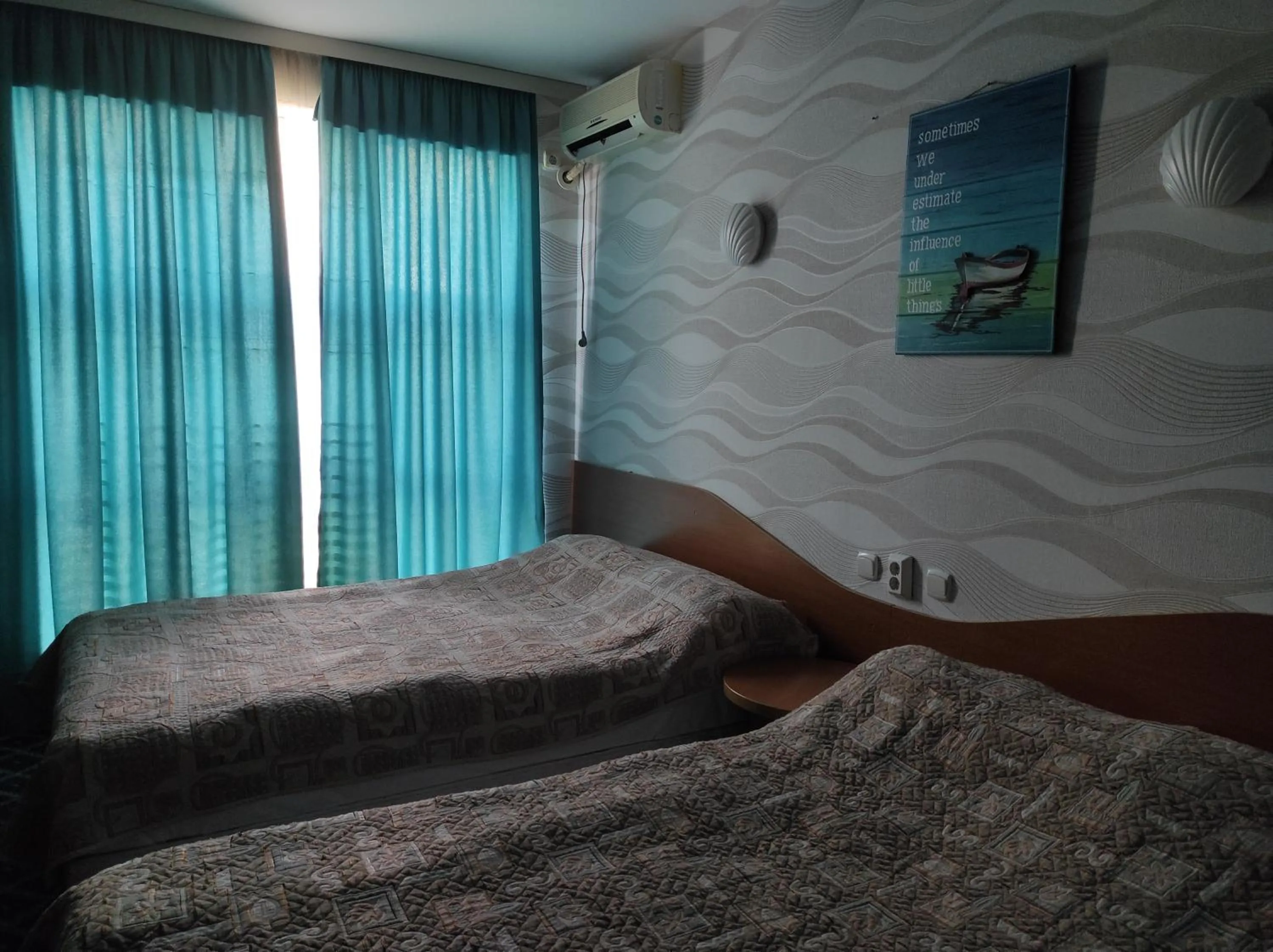 Bed in Three Dolphins Hotel