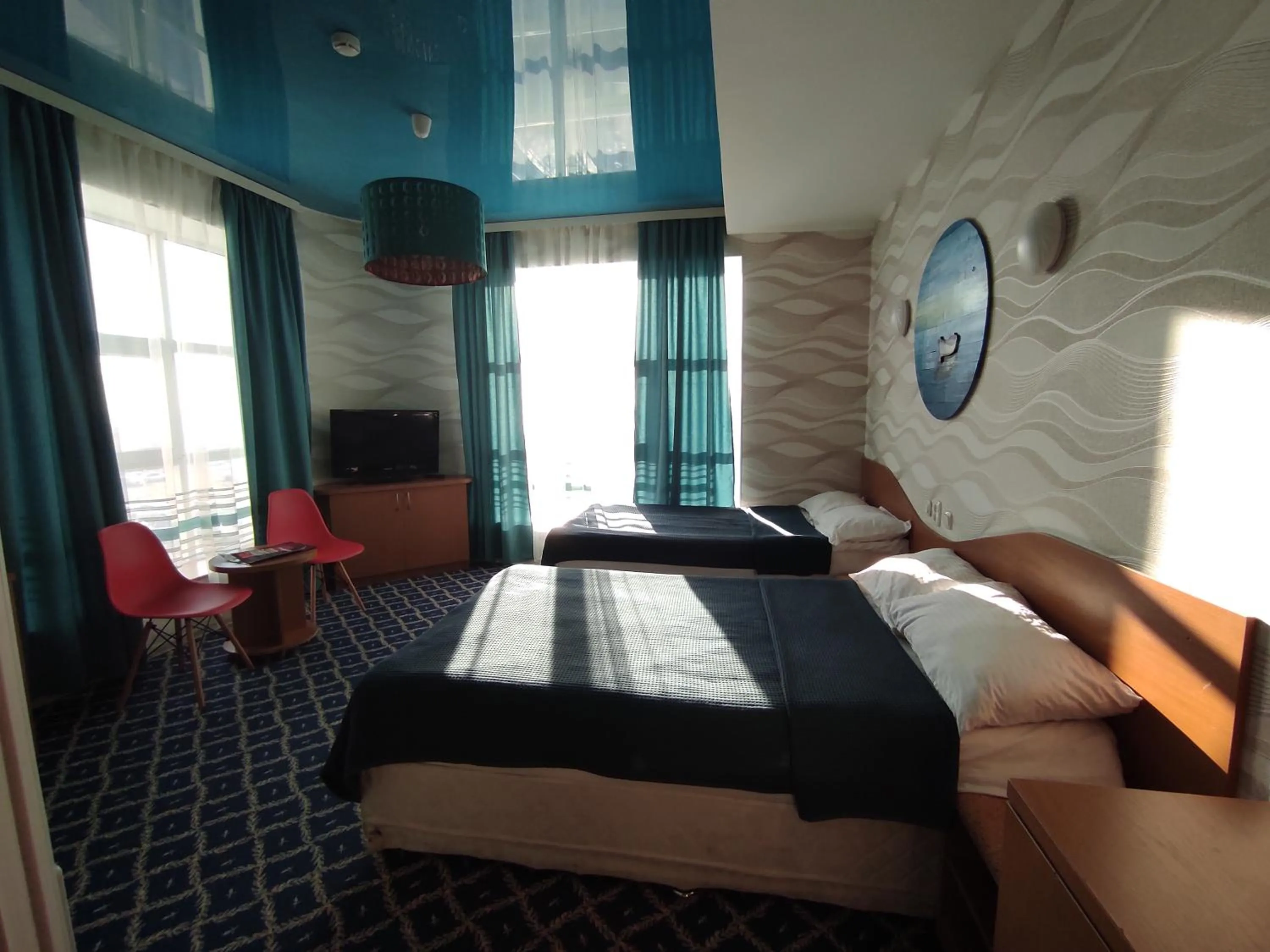 Bed in Three Dolphins Hotel