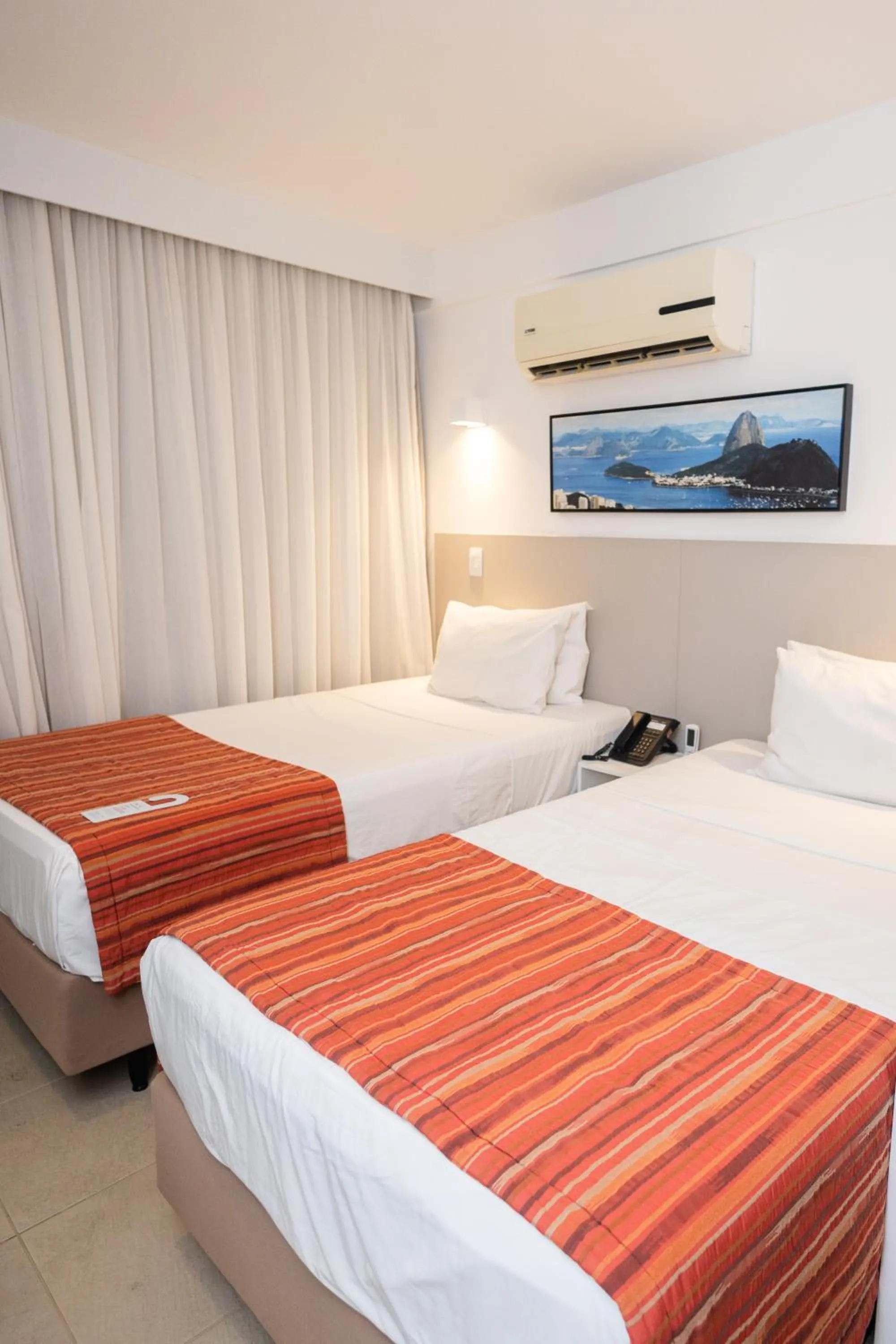 Bed in Ramada by Wyndham Macae Hotel & Suites