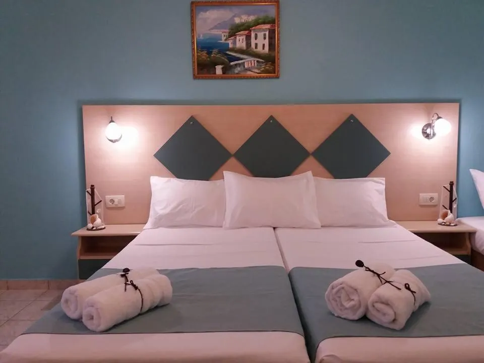 Bed in Vossos Hotel Apartments