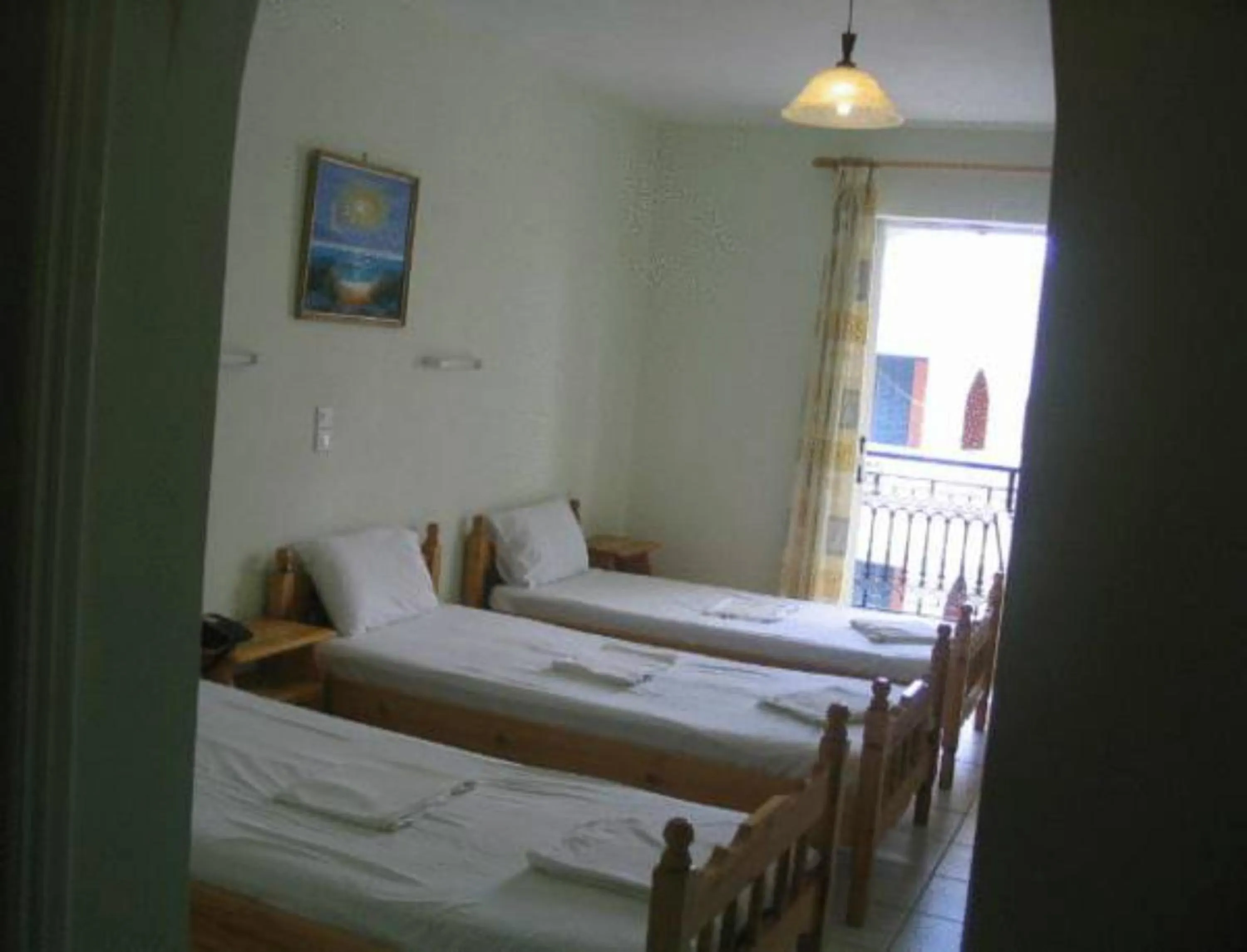 Bed in Vossos Hotel Apartments