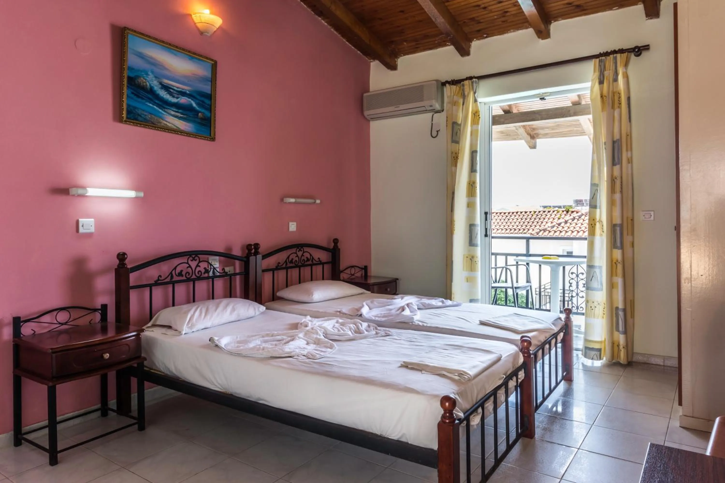 Bed in Vossos Hotel Apartments