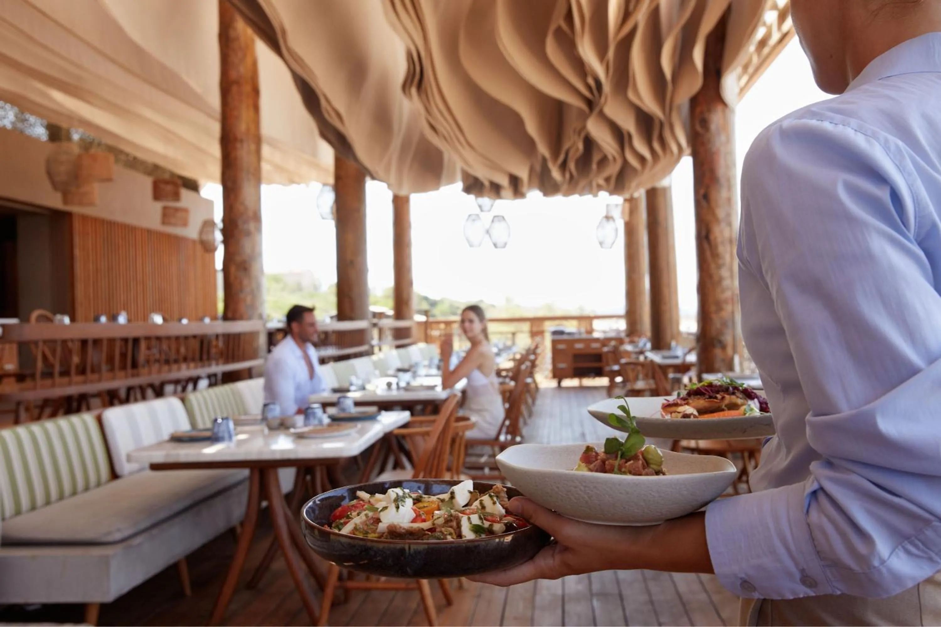 Lounge or bar in The Romanos, a Luxury Collection Resort, Costa Navarino