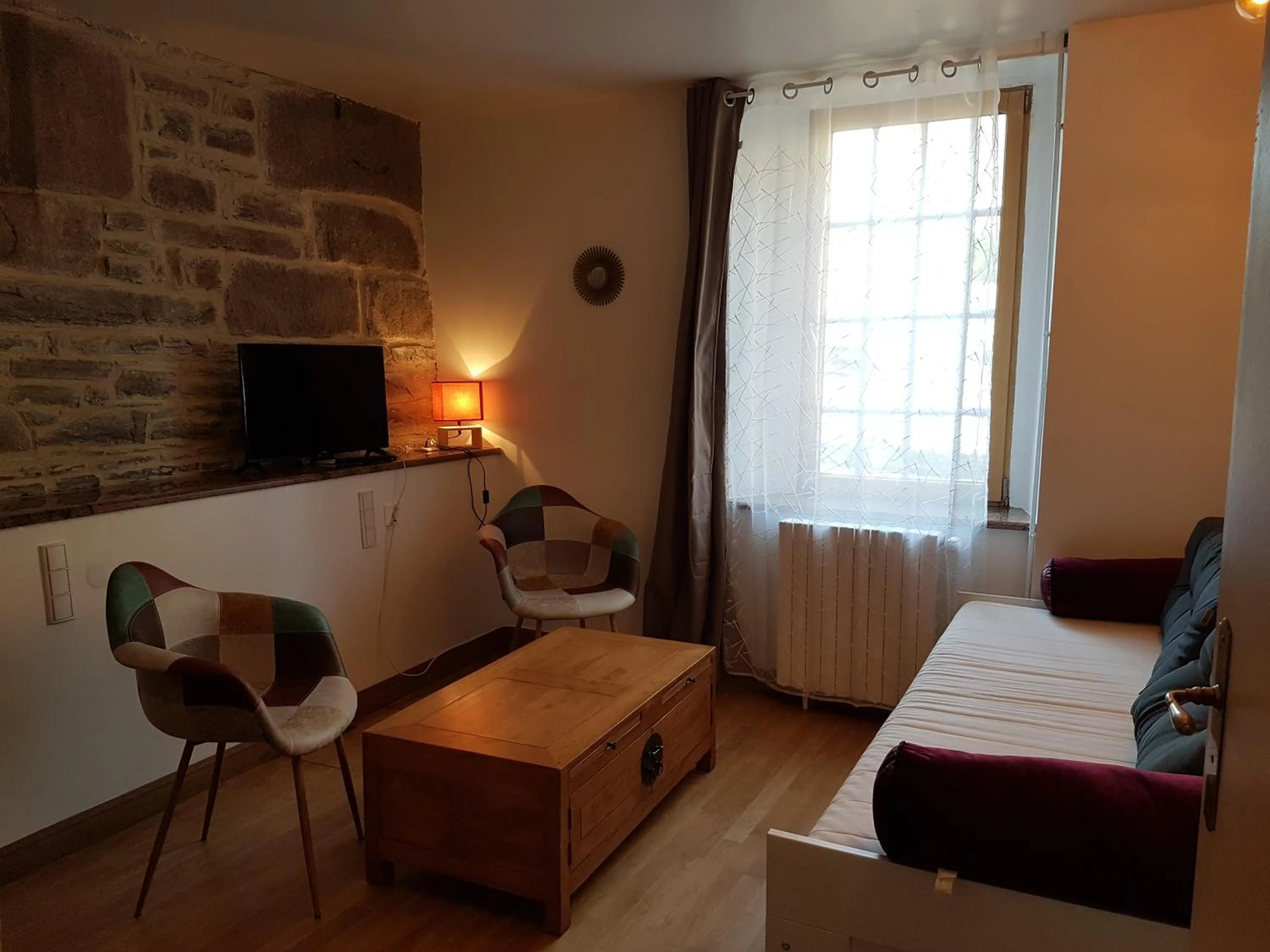 Communal lounge/ TV room, Bed in Les Chambres du Château du Rozel